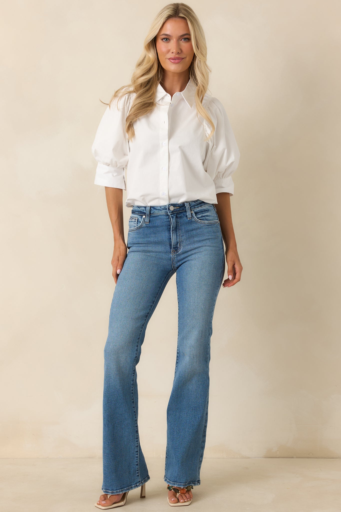 Casual denim jeans showcasing a flattering high-rise waist, soft flare hem, and comfortable relaxed silhouette.