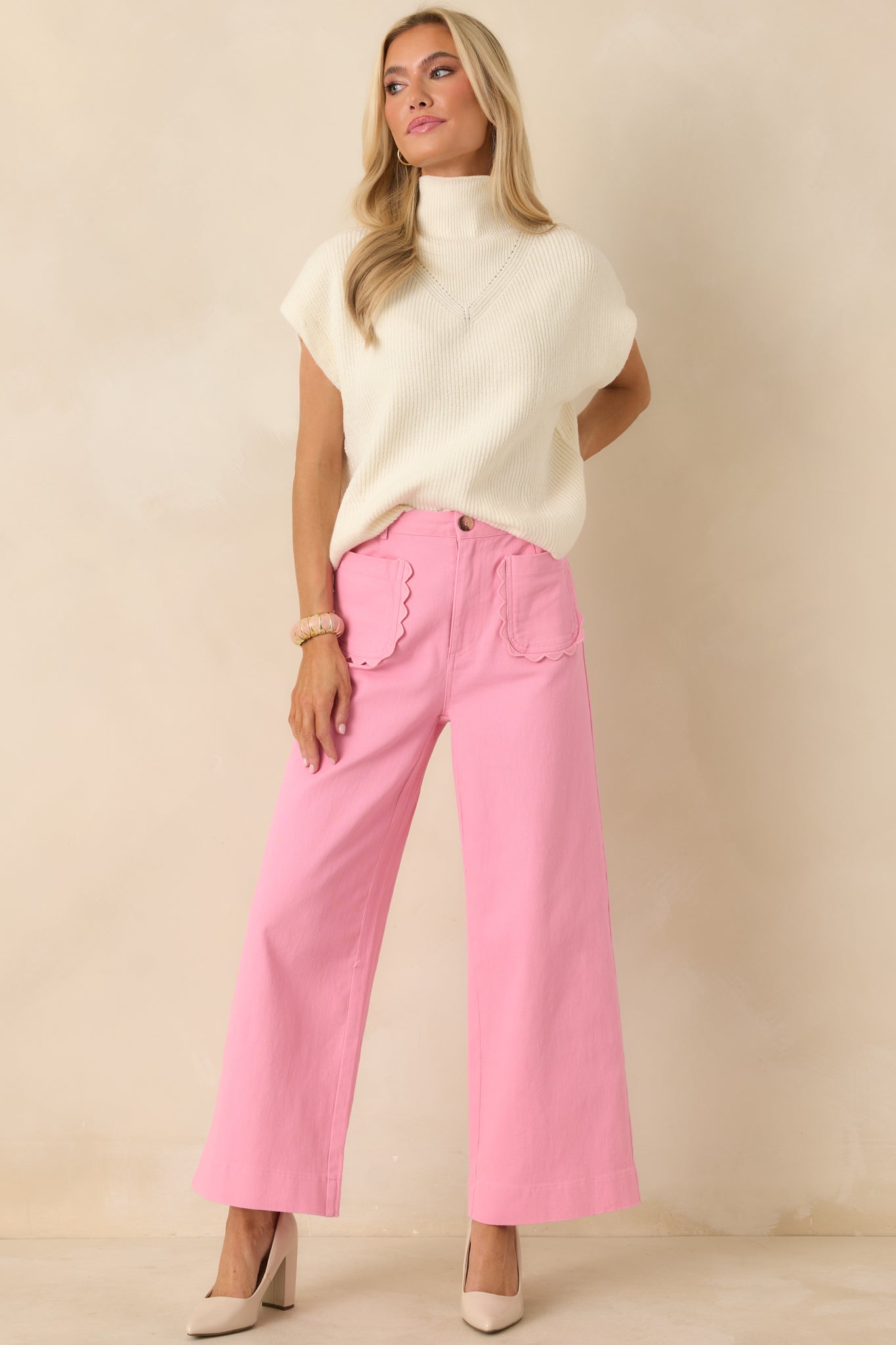 Relaxed-fit ivory sweater top designed with a structured mock collar and gently shaped cap sleeve trim.