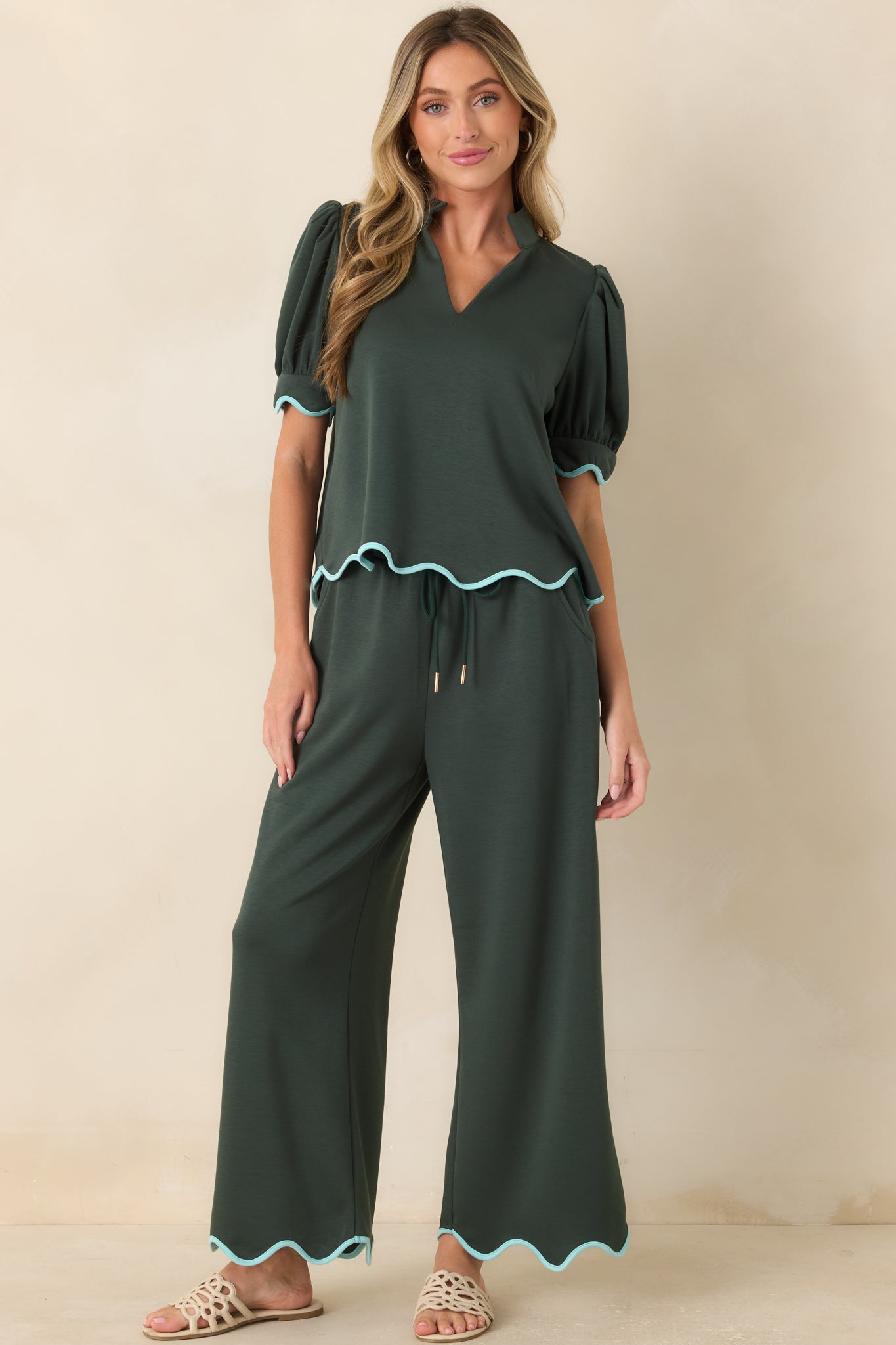 Relaxed knit pants showcasing an adjustable drawstring waist, graceful drape, and mint green accents.