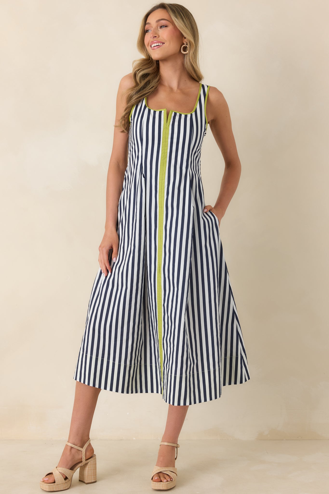 Front view of the relaxed midi dress emphasizing movement, flattering silhouette, and practical side pockets.