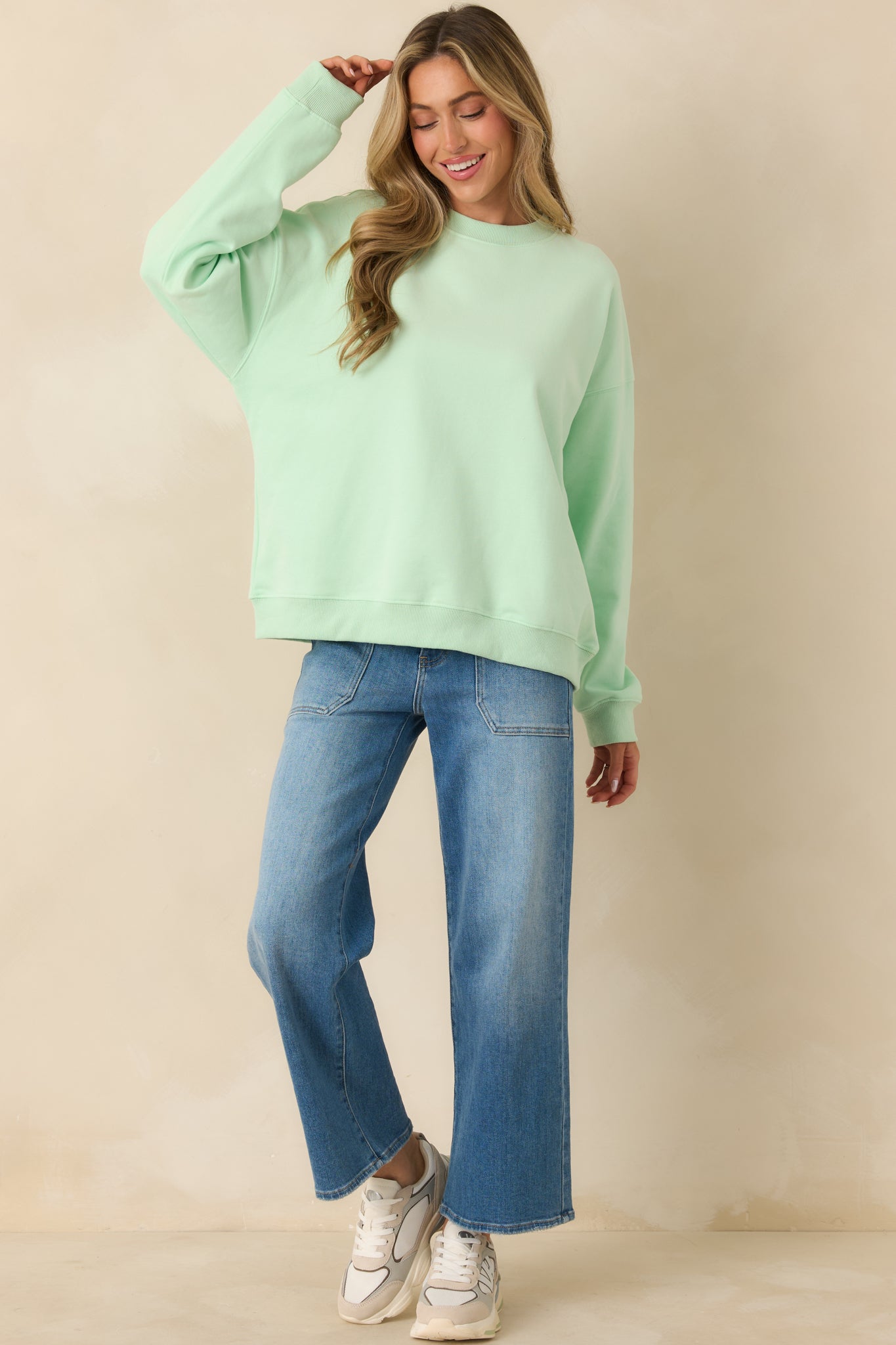 Relaxed-fit mint green knit sweatshirt with ribbed hem for layering comfort.