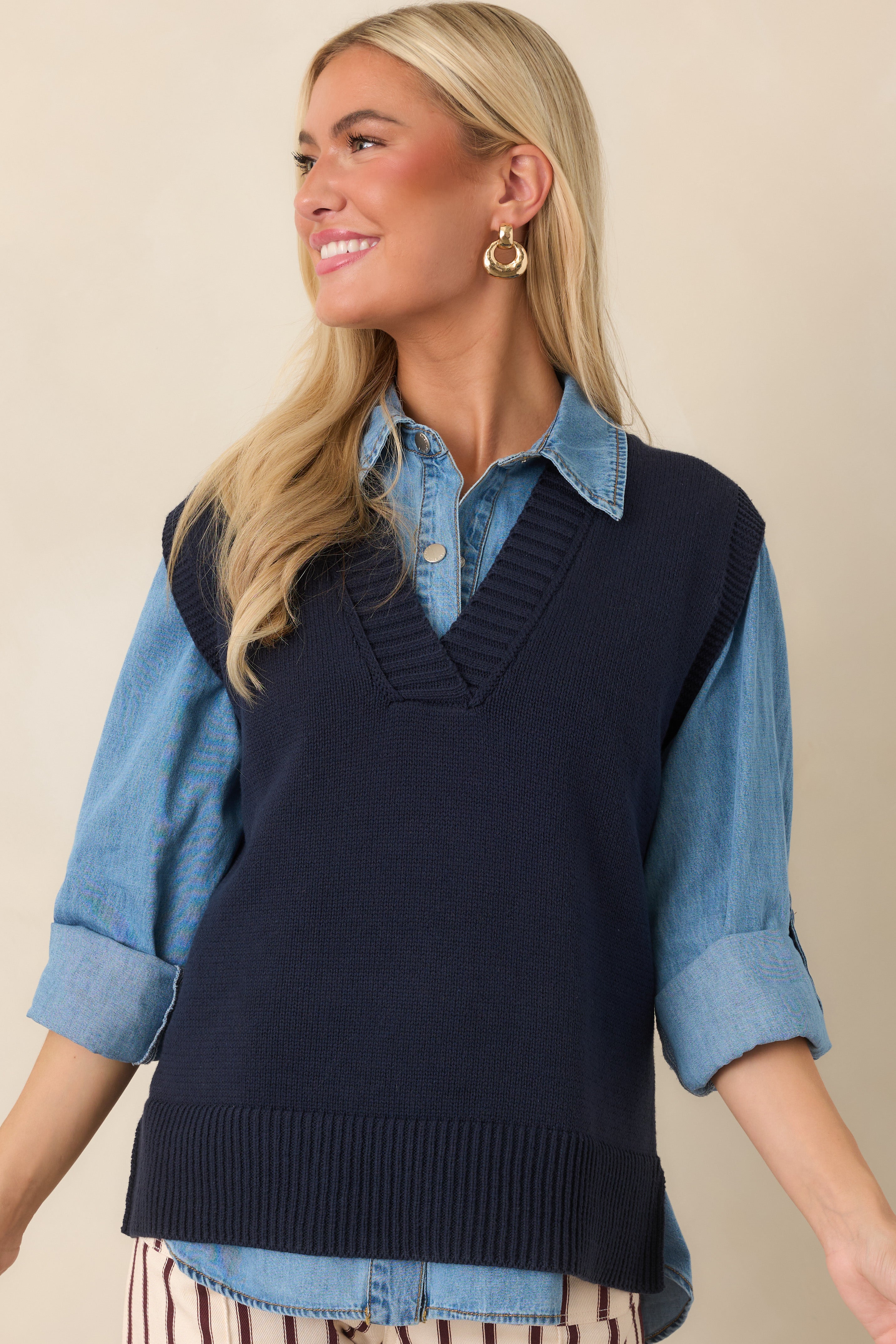 Cropped view of the sleeveless navy vest, showcasing its relaxed shape, soft knit texture, and neatly finished ribbed edges.