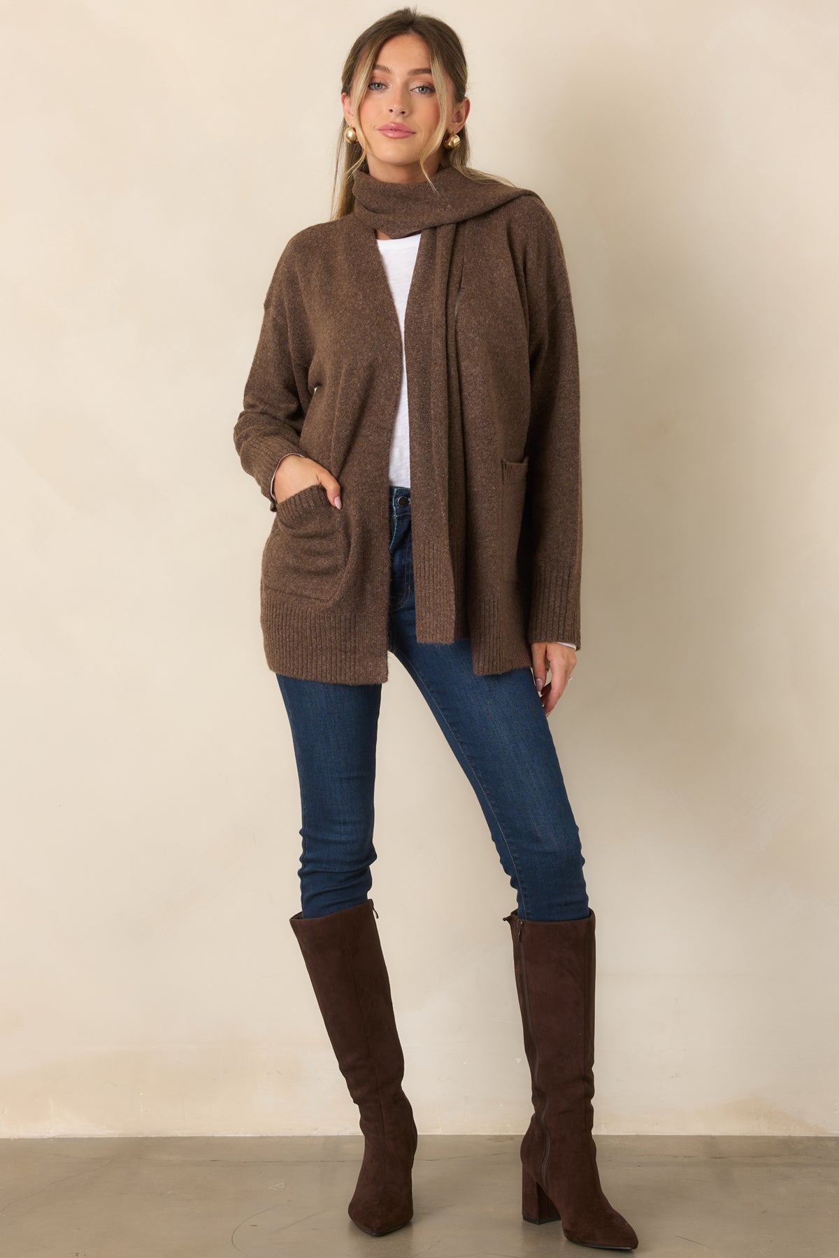 Relaxed open-front cardigan with dropped shoulders, long sleeves, and practical front patch pockets.
