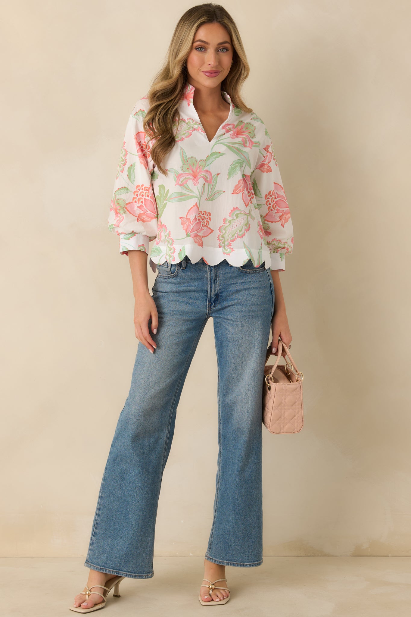 Relaxed-fit peach top with 3/4 sleeves, a flattering V-neck, and subtle multicolor pattern.