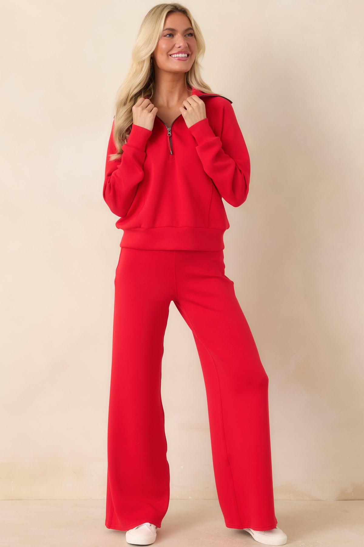 Relaxed pullover showcasing a silky-smooth finish, coordinating cuffs, and a modern half-zip neckline.