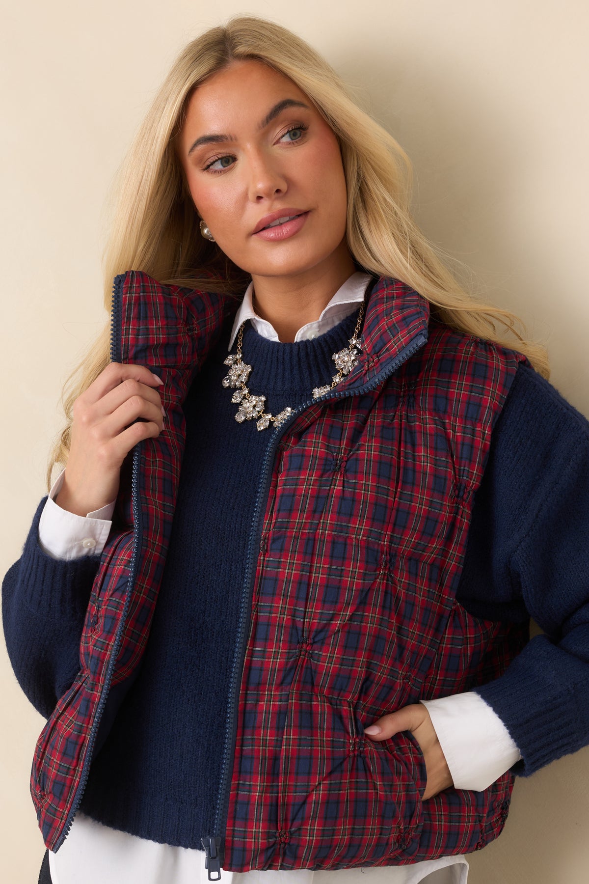 Relaxed vest silhouette with a stand collar and rounded quilted construction.