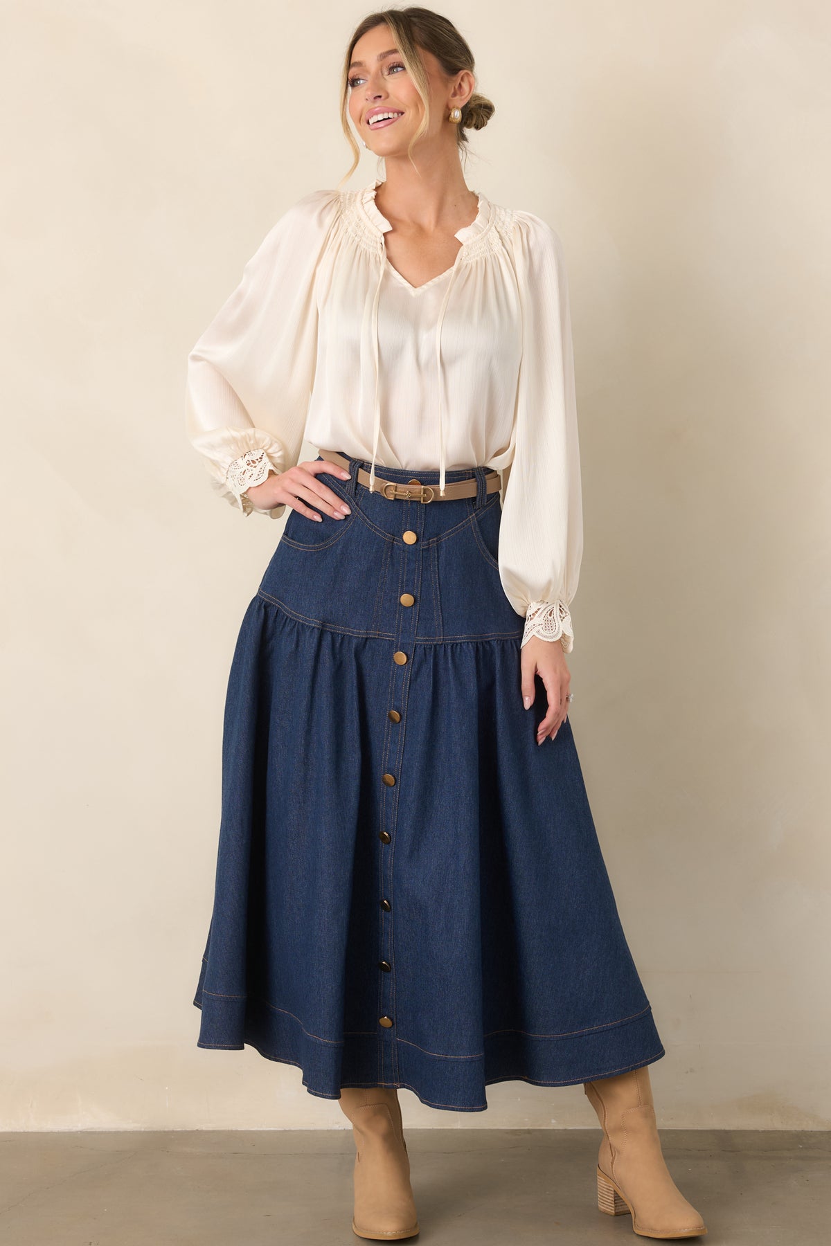 Relaxed top featuring a softly gathered ruffle neckline, V-shaped opening, gold-tone tipped ties, and voluminous balloon sleeves.