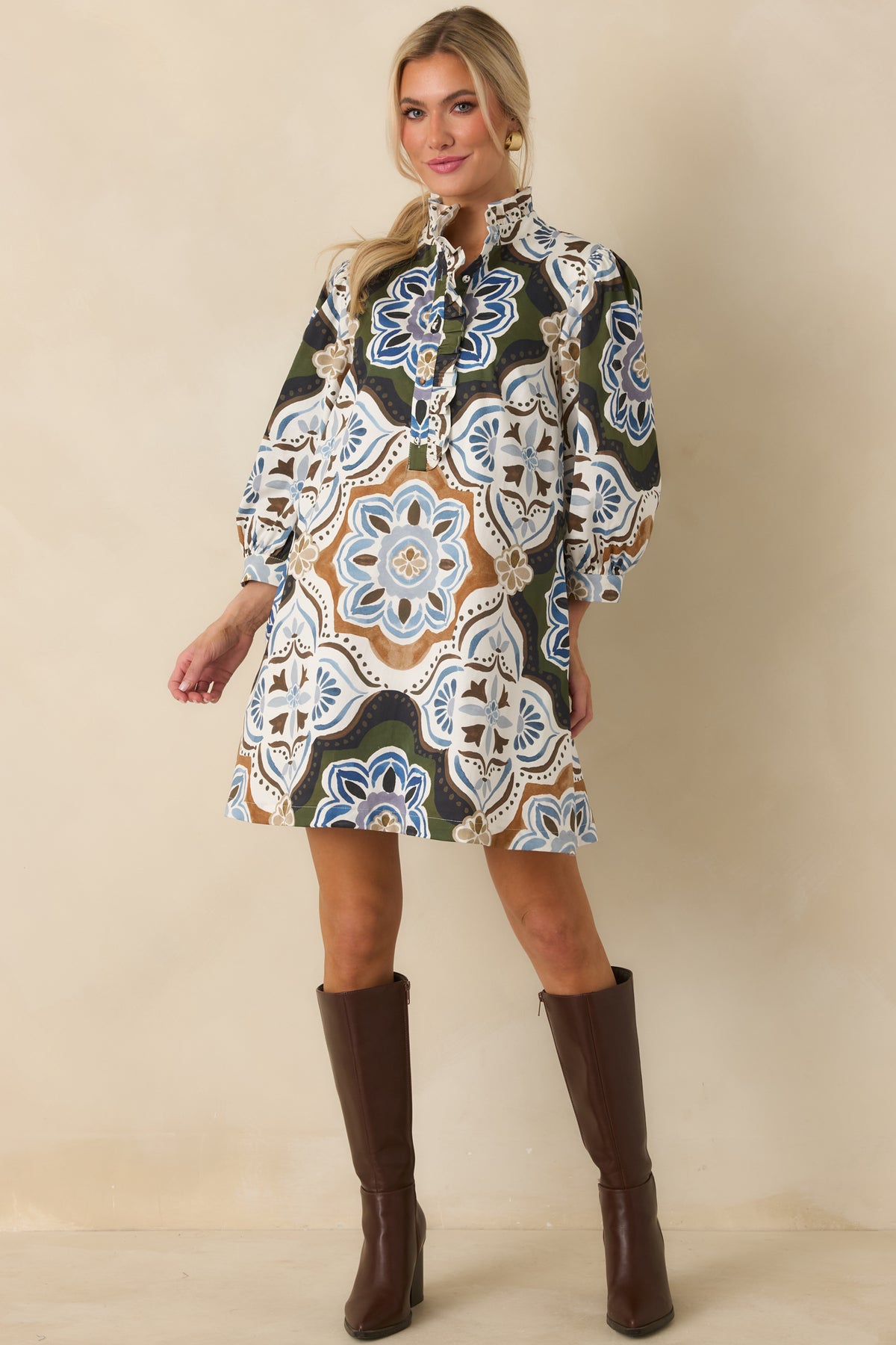 Relaxed shift dress featuring a split neckline framed by coordinating ruffle trim and three-quarter balloon sleeves.