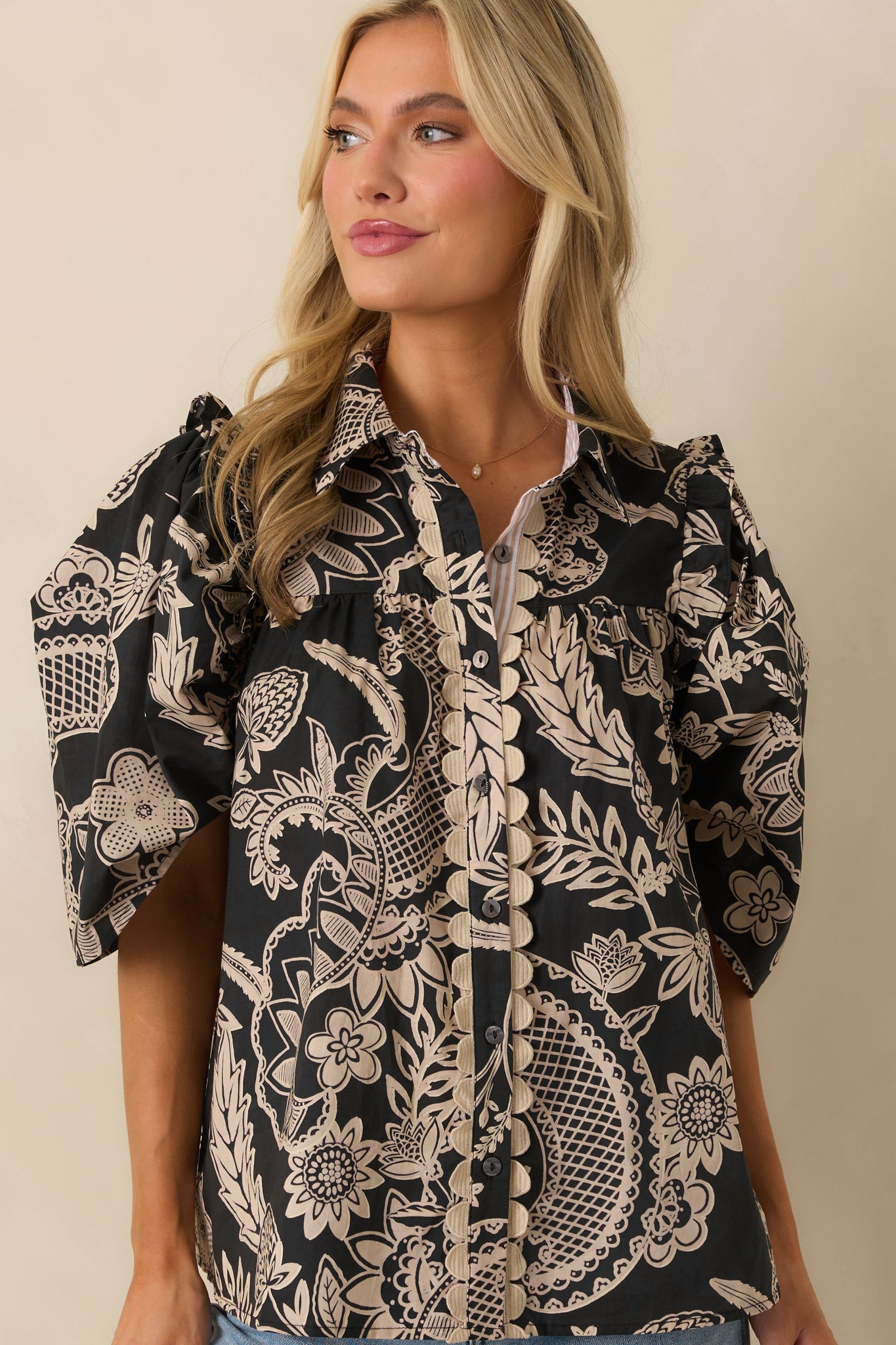 Front close-up showing the relaxed silhouette and floral print across the torso.
