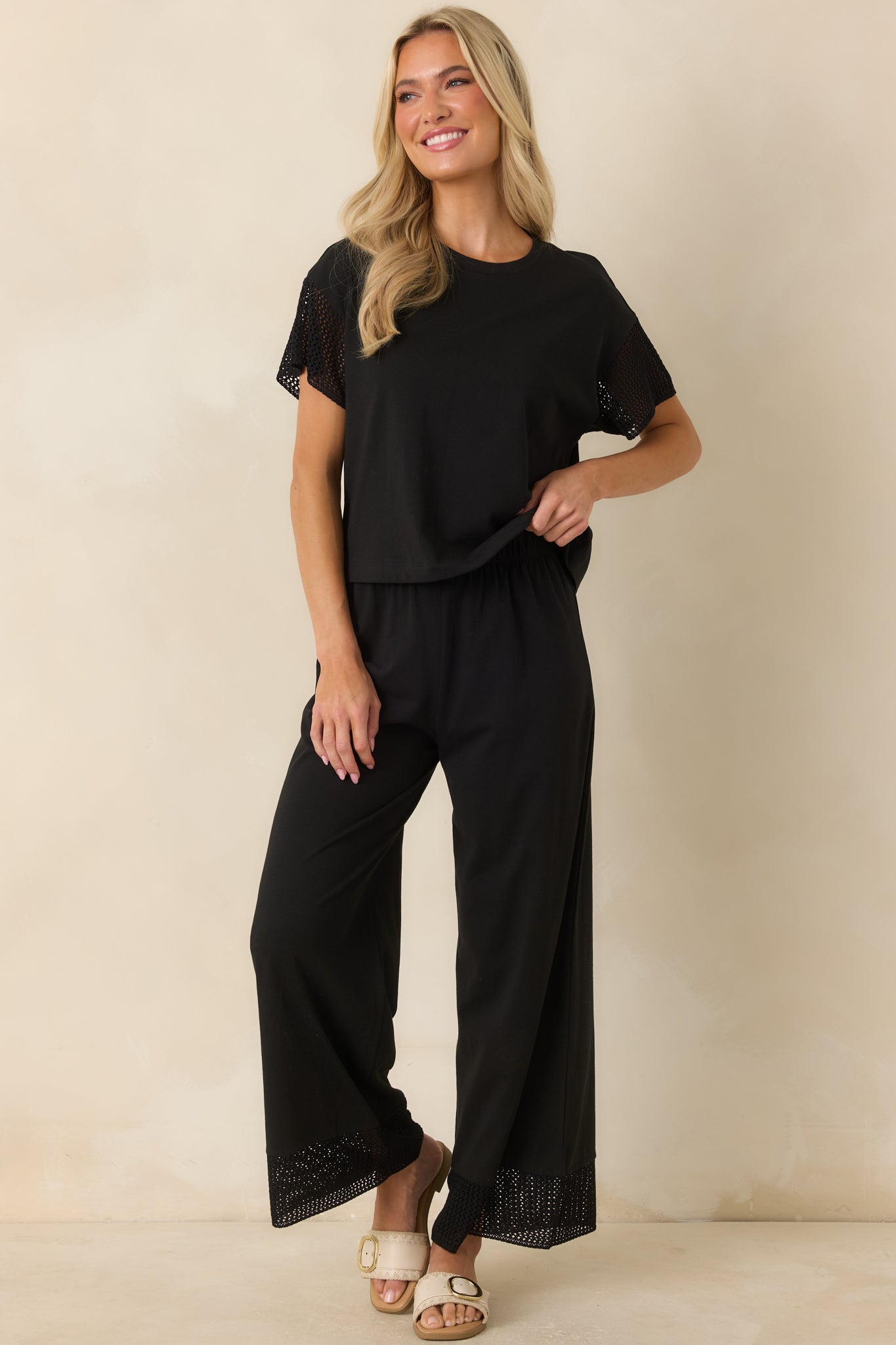 Relaxed straight-leg black pants crafted from a cotton and lyocell blend with a comfortable elastic waistband and crochet lace hem.