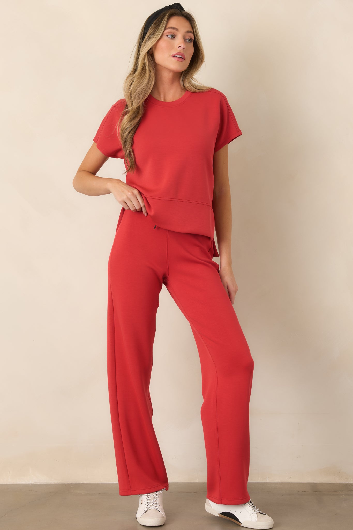 Relaxed straight-leg pants with a pull-on waistband, adjustable drawstring, and fluid four-way stretch construction for comfortable movement.