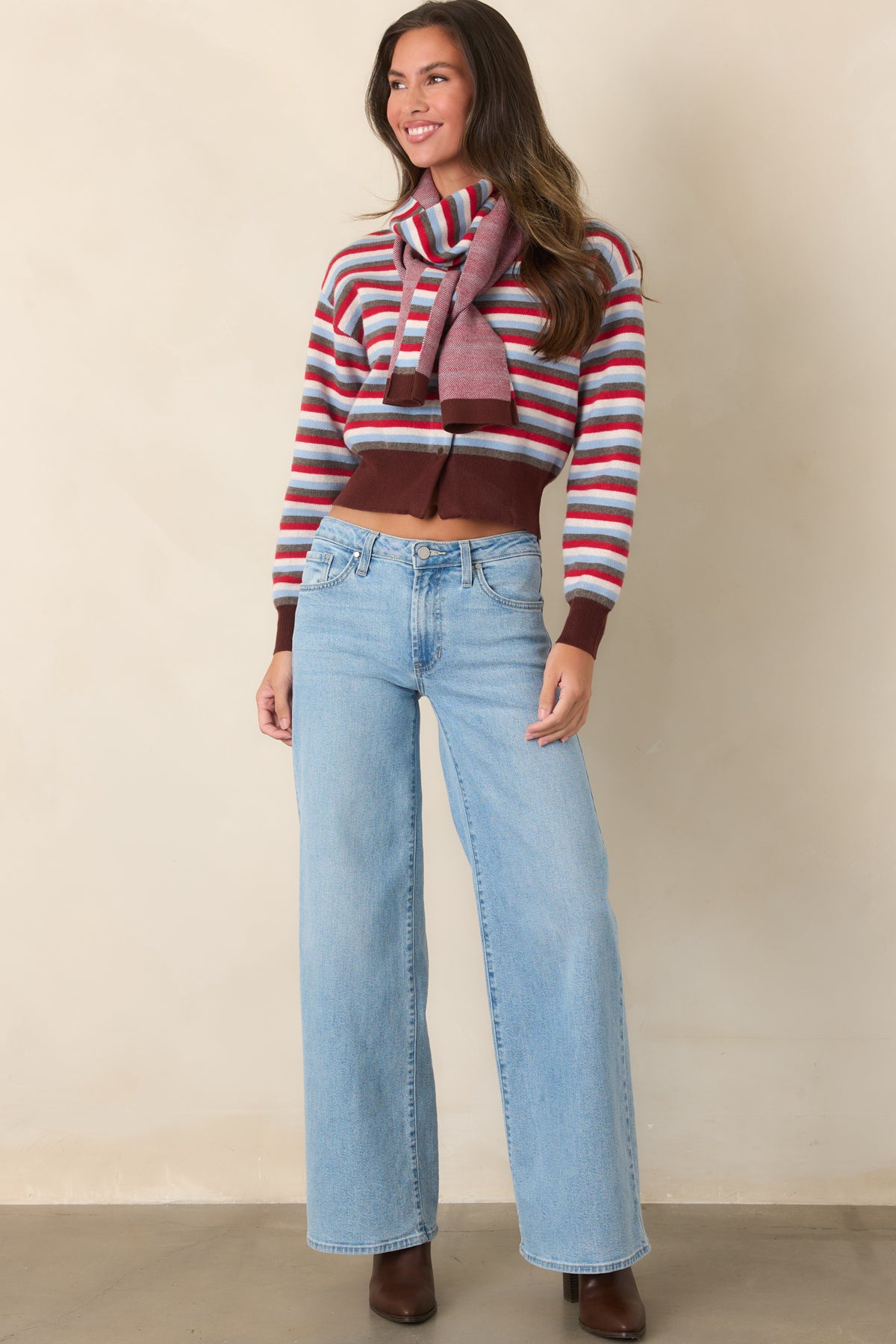 Relaxed striped cardigan featuring a brown ribbed neckline, cuffs, and hem with long sleeves.