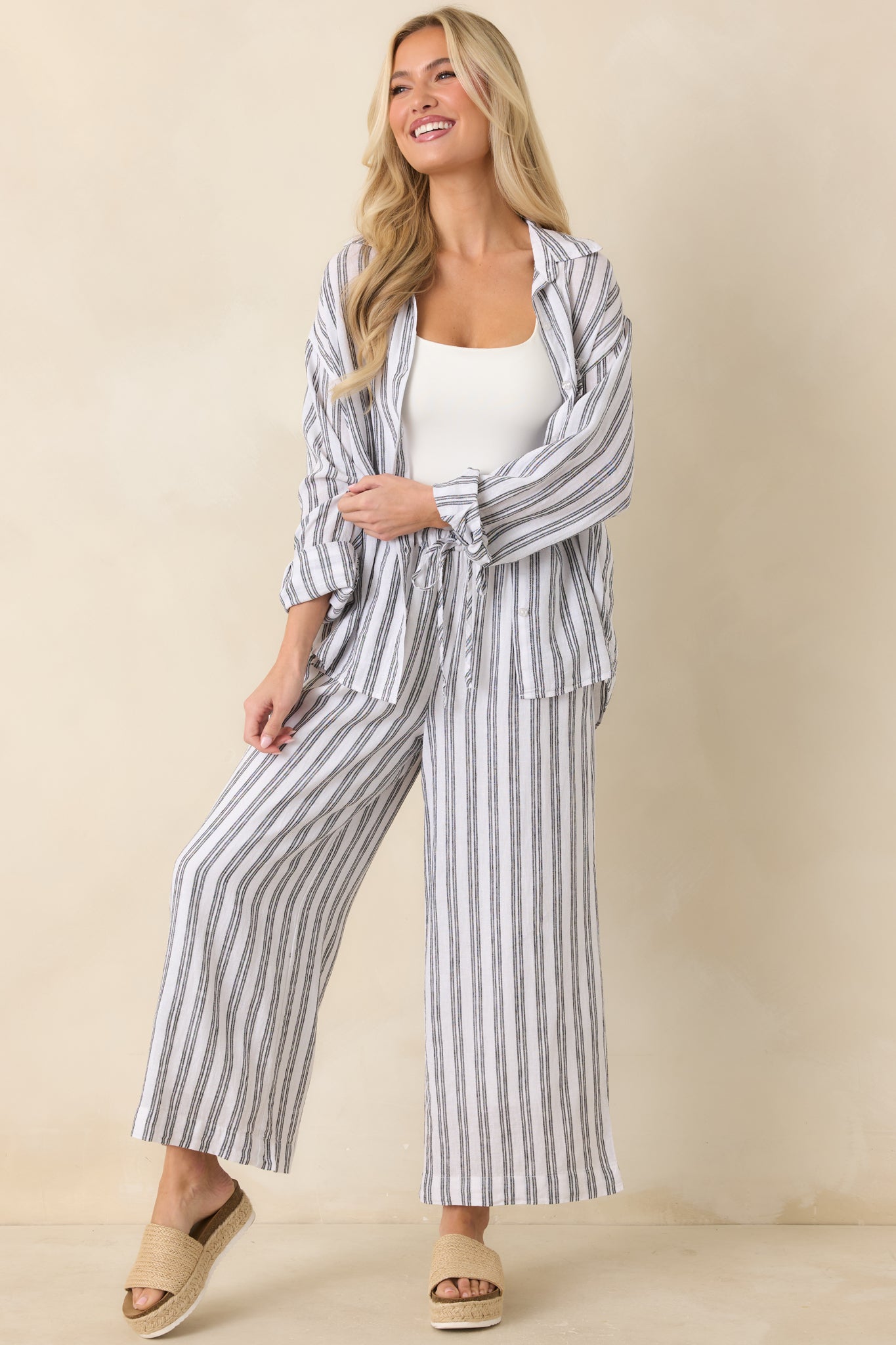 Relaxed striped shirt with long sleeves, structured collar, and timeless button front design.