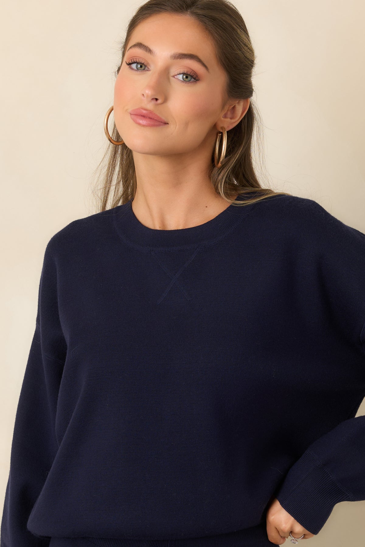 Ribbed hemline adds a classic finish to the relaxed sweater-knit pullover.