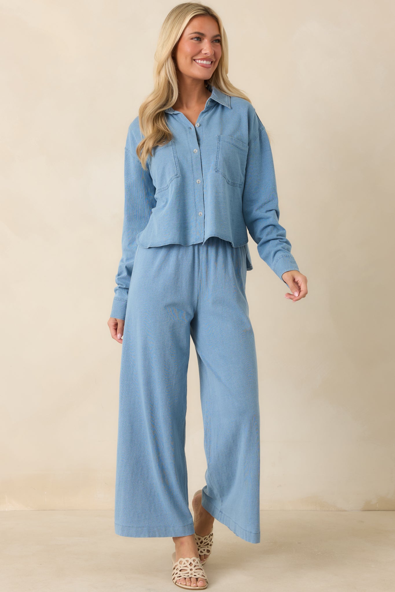 Relaxed fit top designed with a polished collar, functional buttons, and front pocket details.