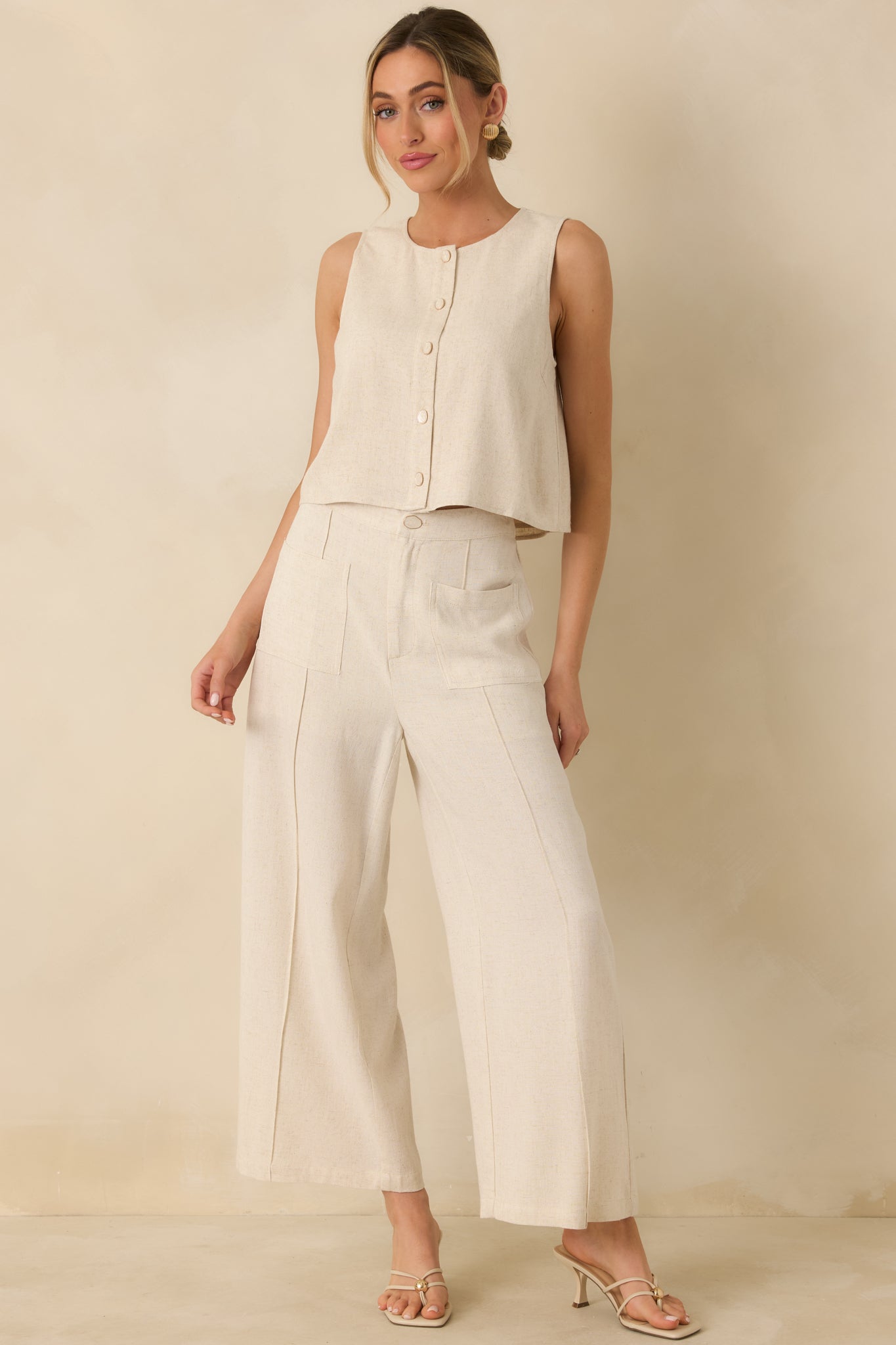 Relaxed-fit natural top with subtle fabric texture, sleeveless design, and clean rounded neckline.