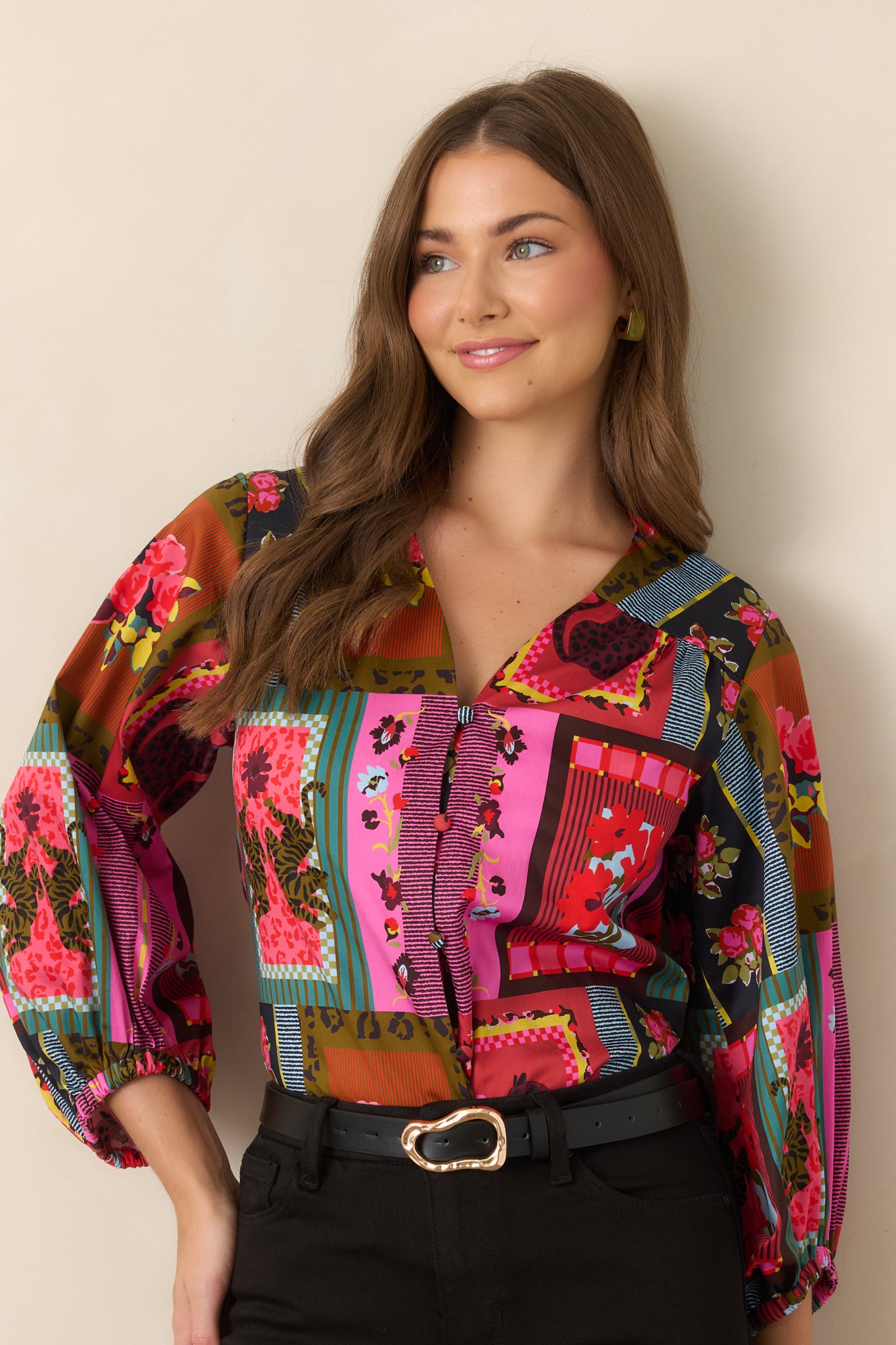 Relaxed-fit blouse showcasing the flowing sleeve volume, gathered cuff detailing, and bold patchwork-inspired print.