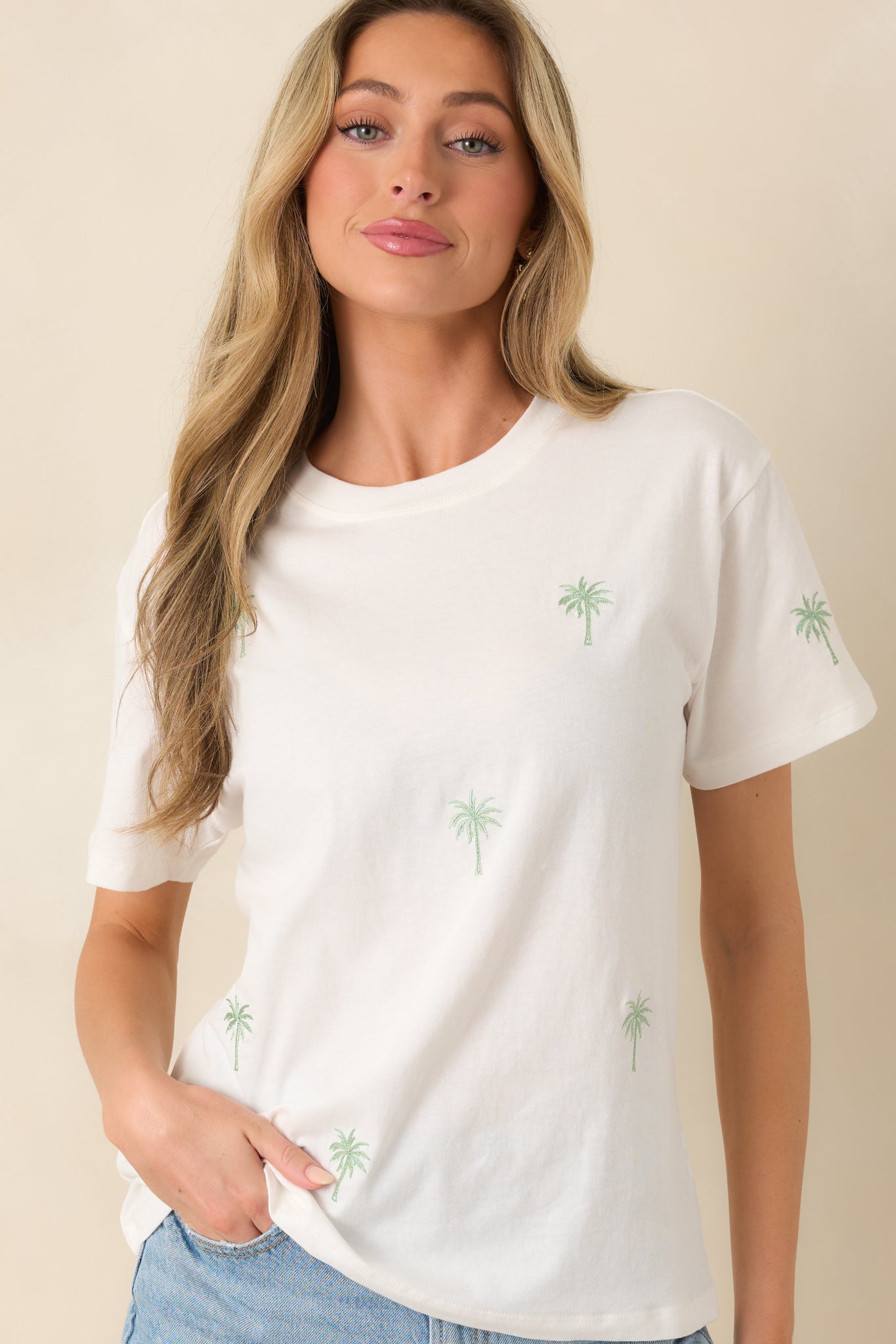 Relaxed white boyfriend tee with subtle coastal embroidery and smooth fabric.