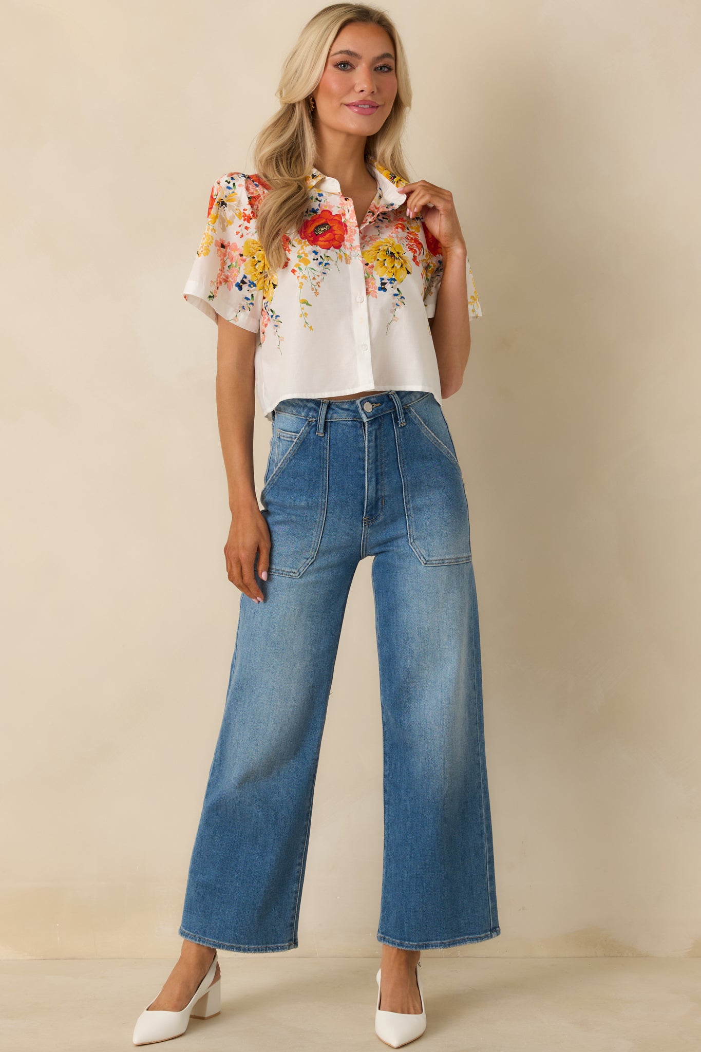Relaxed white button-down top showcasing a colorful floral print and crisp collared neckline.