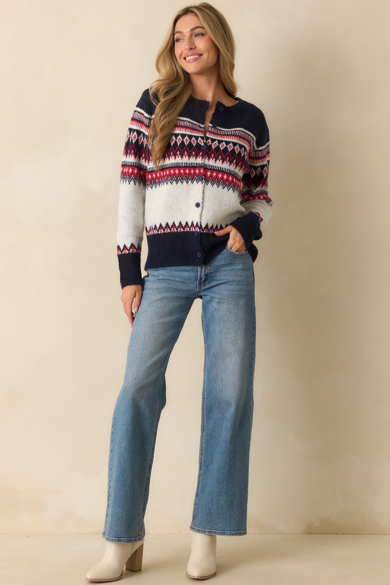 White knit cardigan with Fair Isle pattern in navy and red, front button closure, and relaxed fit.