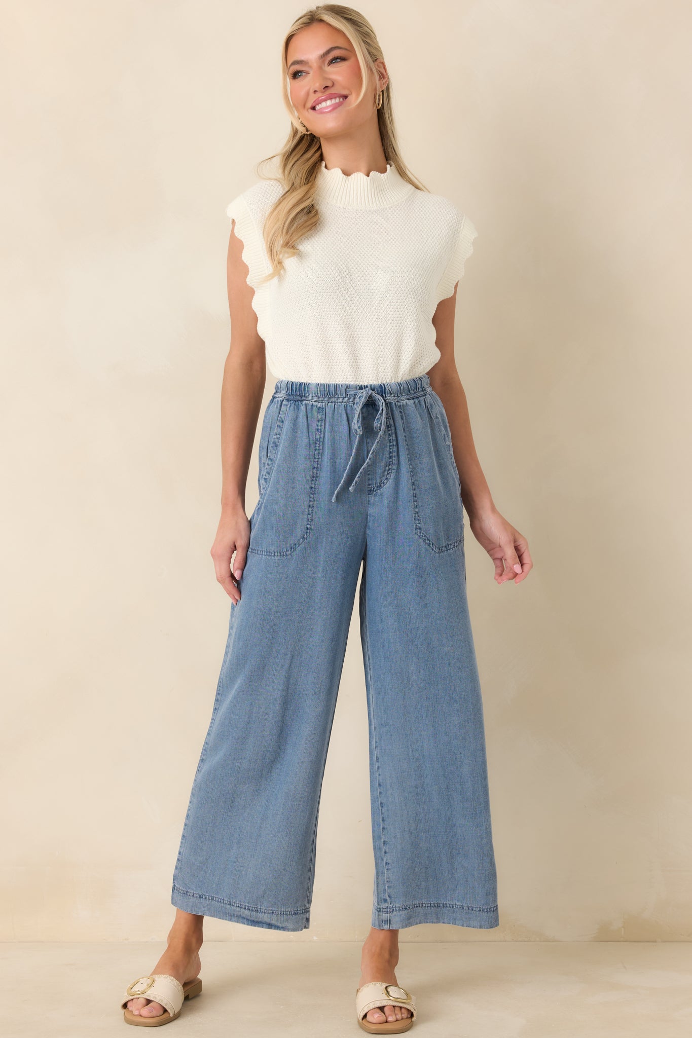 Relaxed wide-leg pants with elastic waist, adjustable drawstring, and functional front patch pockets.