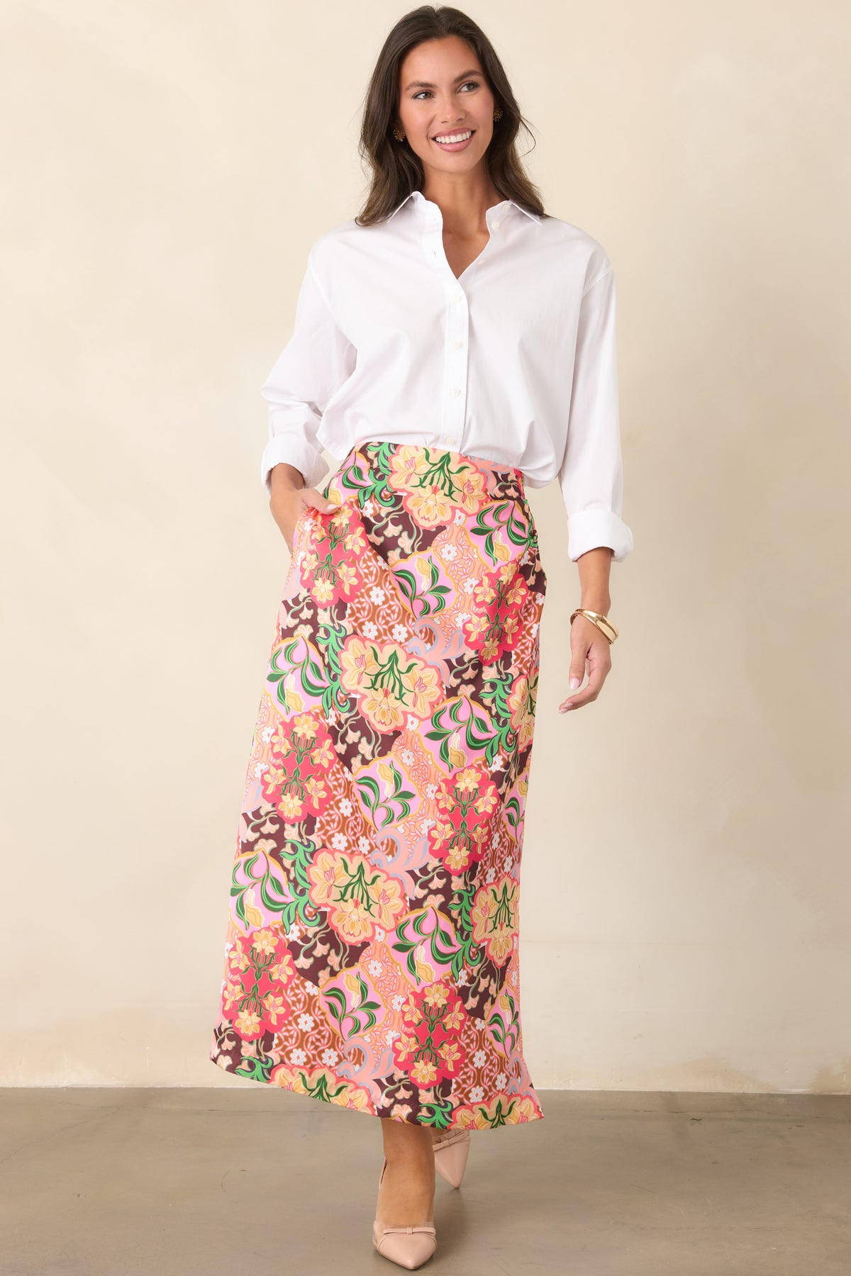 Retro-inspired skirt showcasing multicolored floral medallions and a softly flared shape that falls to a midi hem.
