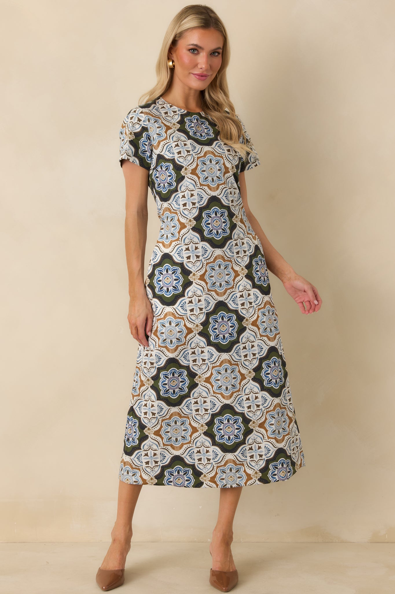 Reversible cotton dress displaying an intricate multicolor medallion pattern with a classic round neckline and convenient pockets.