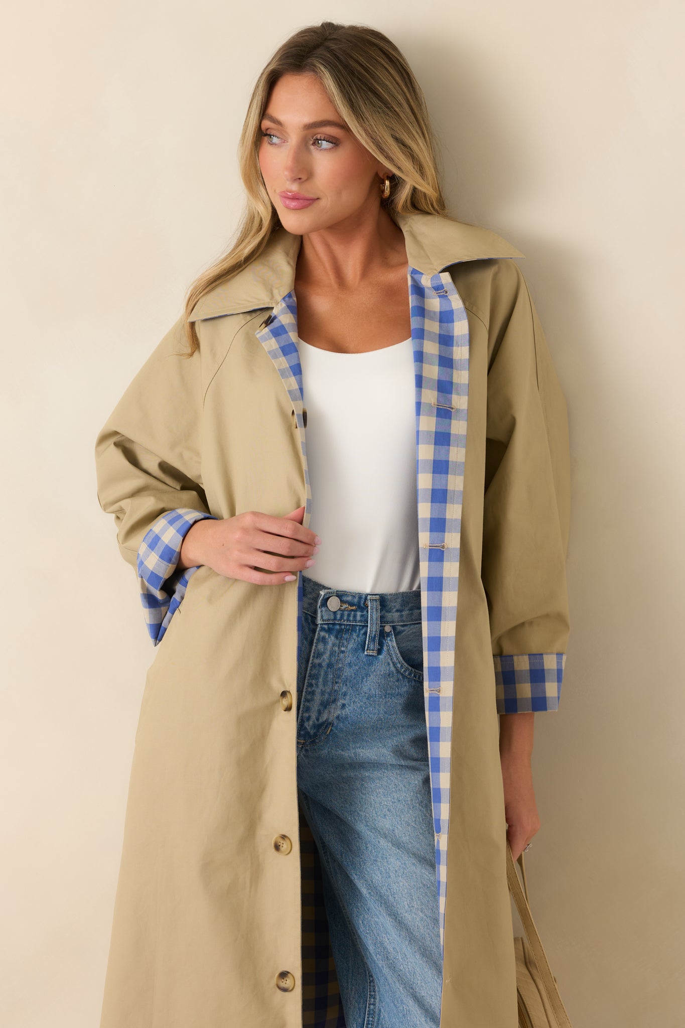 Reversible lightweight coat featuring a tailored collar, button-front design, and self-tie belt for an adjustable fit.