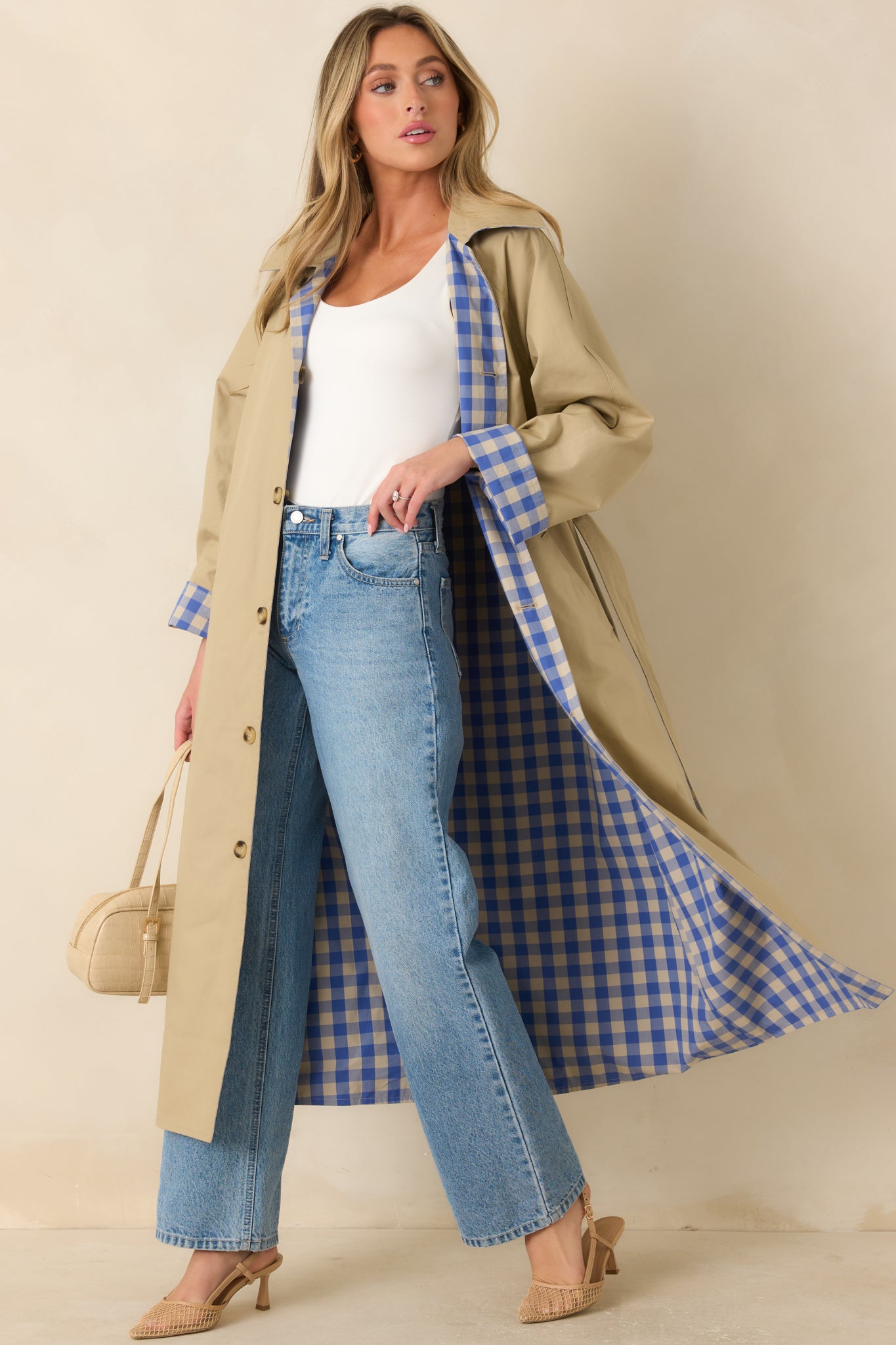Reversible long cotton coat displayed with the solid beige side outward, featuring a contrasting gingham collar, removable self-tie belt, and full-length button closure.