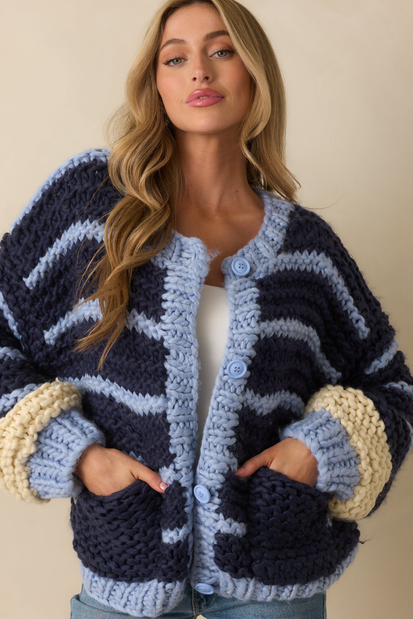 Close view of the ribbed cuffs and powder blue and ivory stripe detailing on the sleeve.