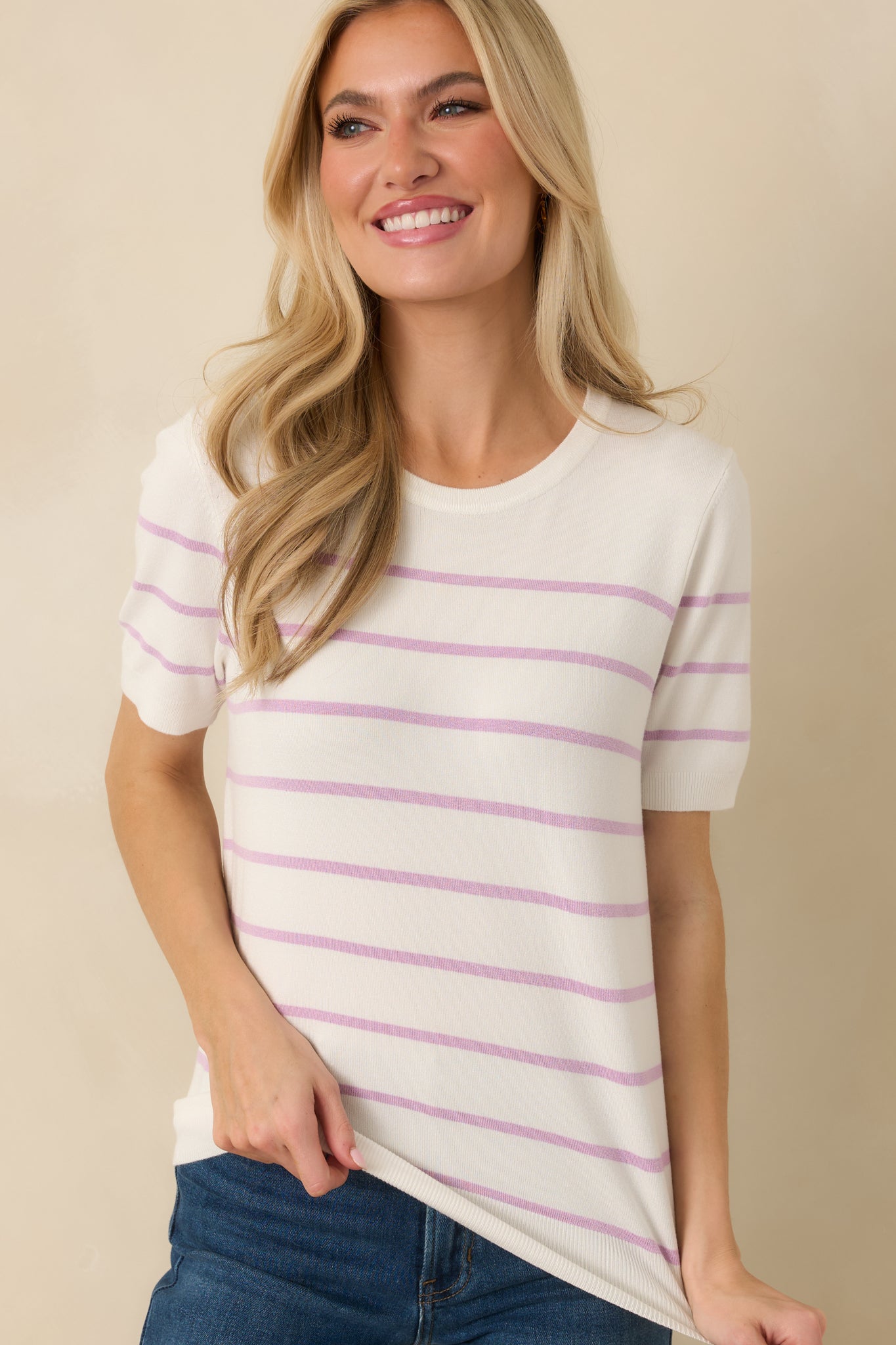 Ribbed hemline and lavender stripe detail along the bottom edge of the sweater.