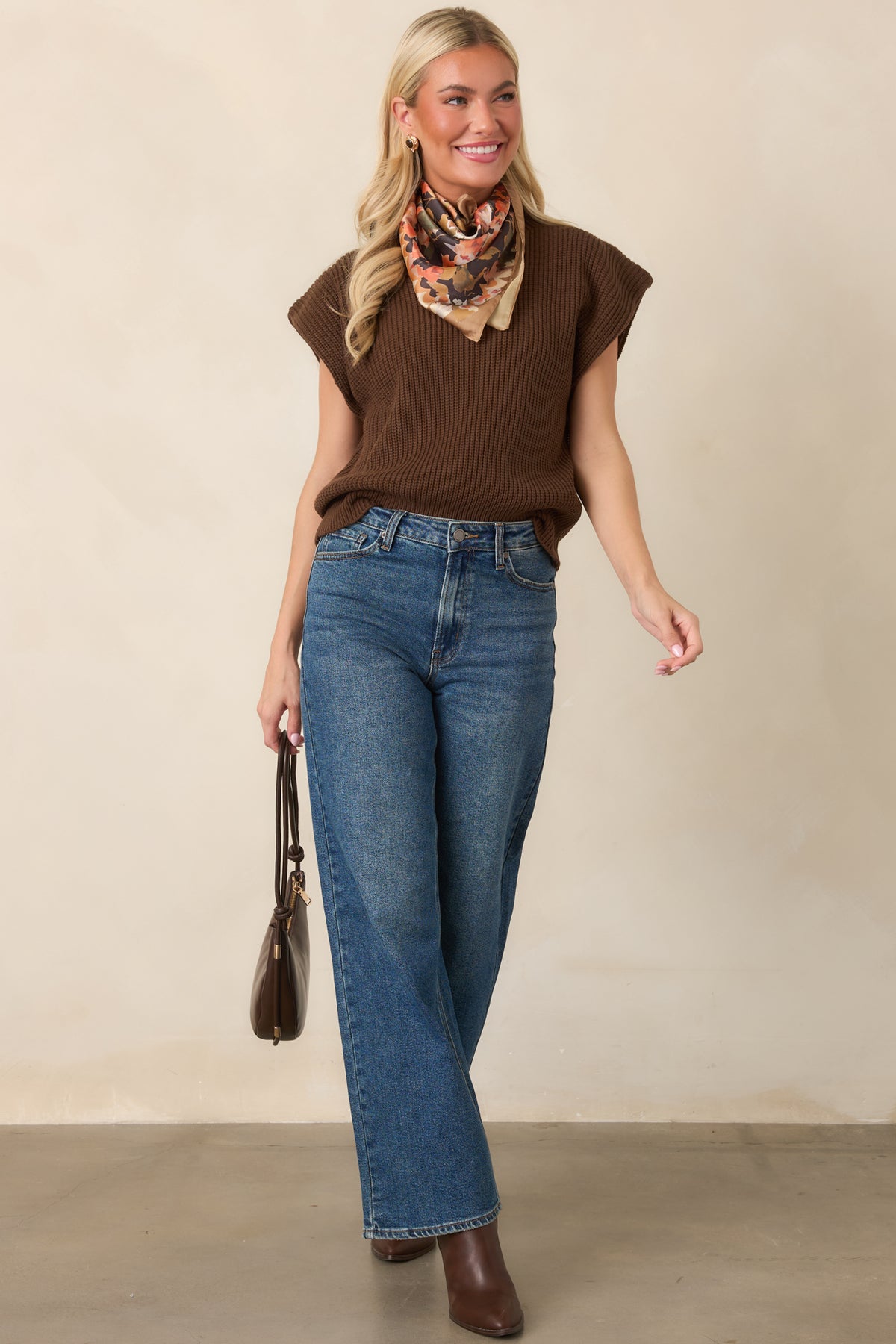 Ribbed knit top designed with a modern silhouette, extended shoulders, and a wide hem that gently defines the waist.