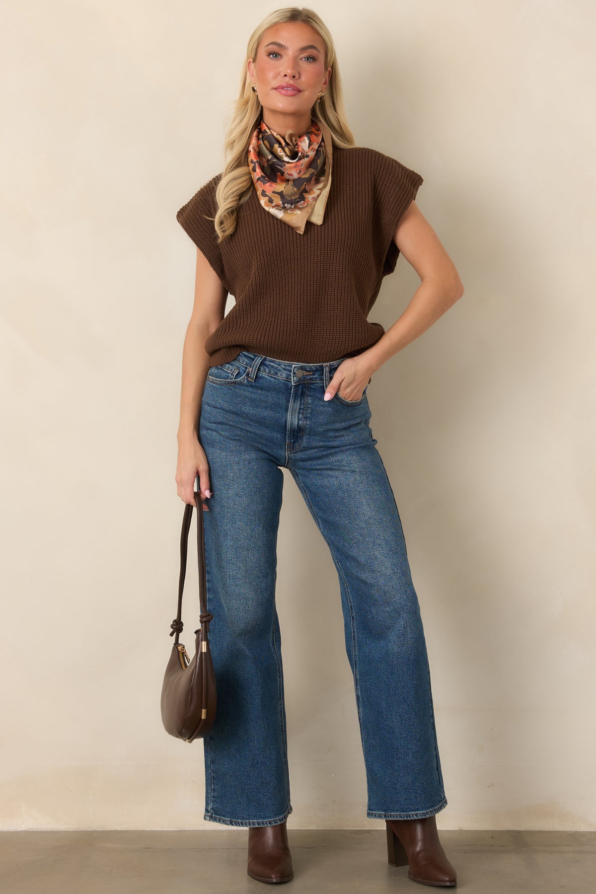 Cozy ribbed knit top featuring a structured mock neckline, slightly extended shoulders, relaxed bodice, and wide ribbed hem.