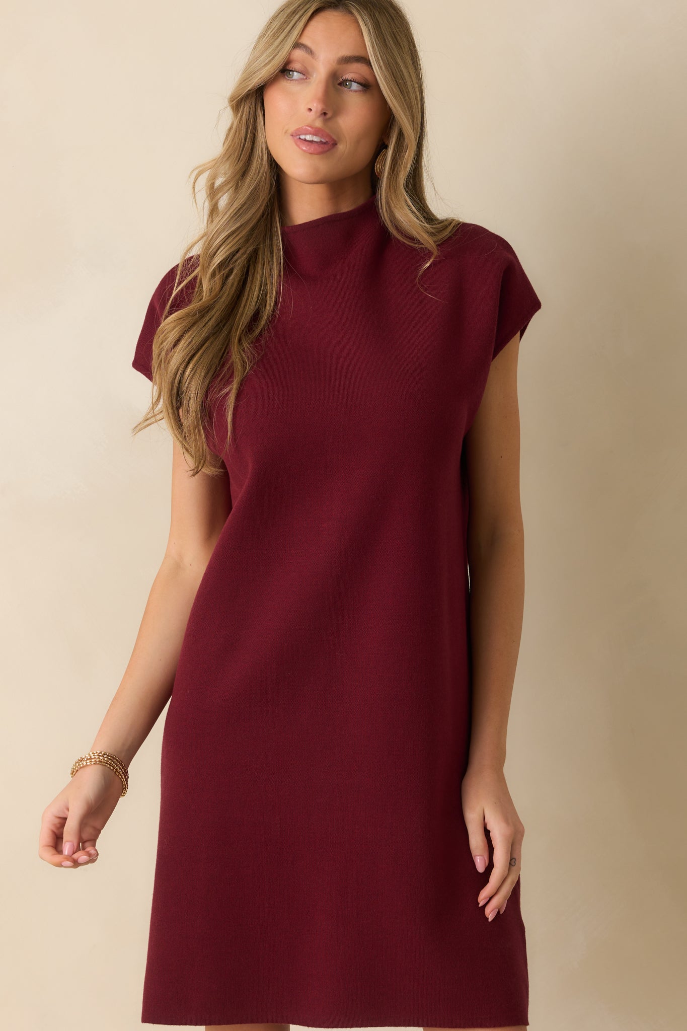 Detail of the dress’s ribbed knit texture and relaxed fit around the bust and waist.
