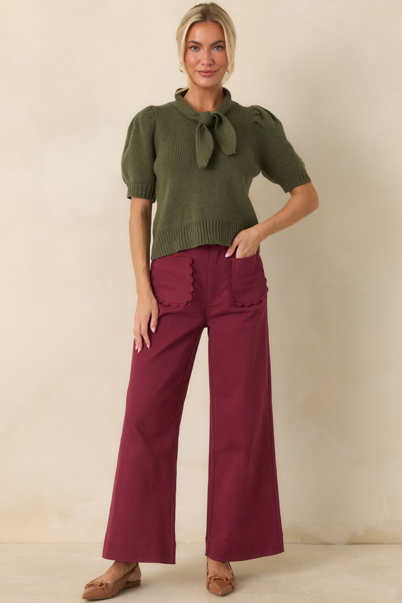 Ribbed knit top with an elegant oversized bow, ribbed cuffs, and a flattering, close-fitting silhouette.