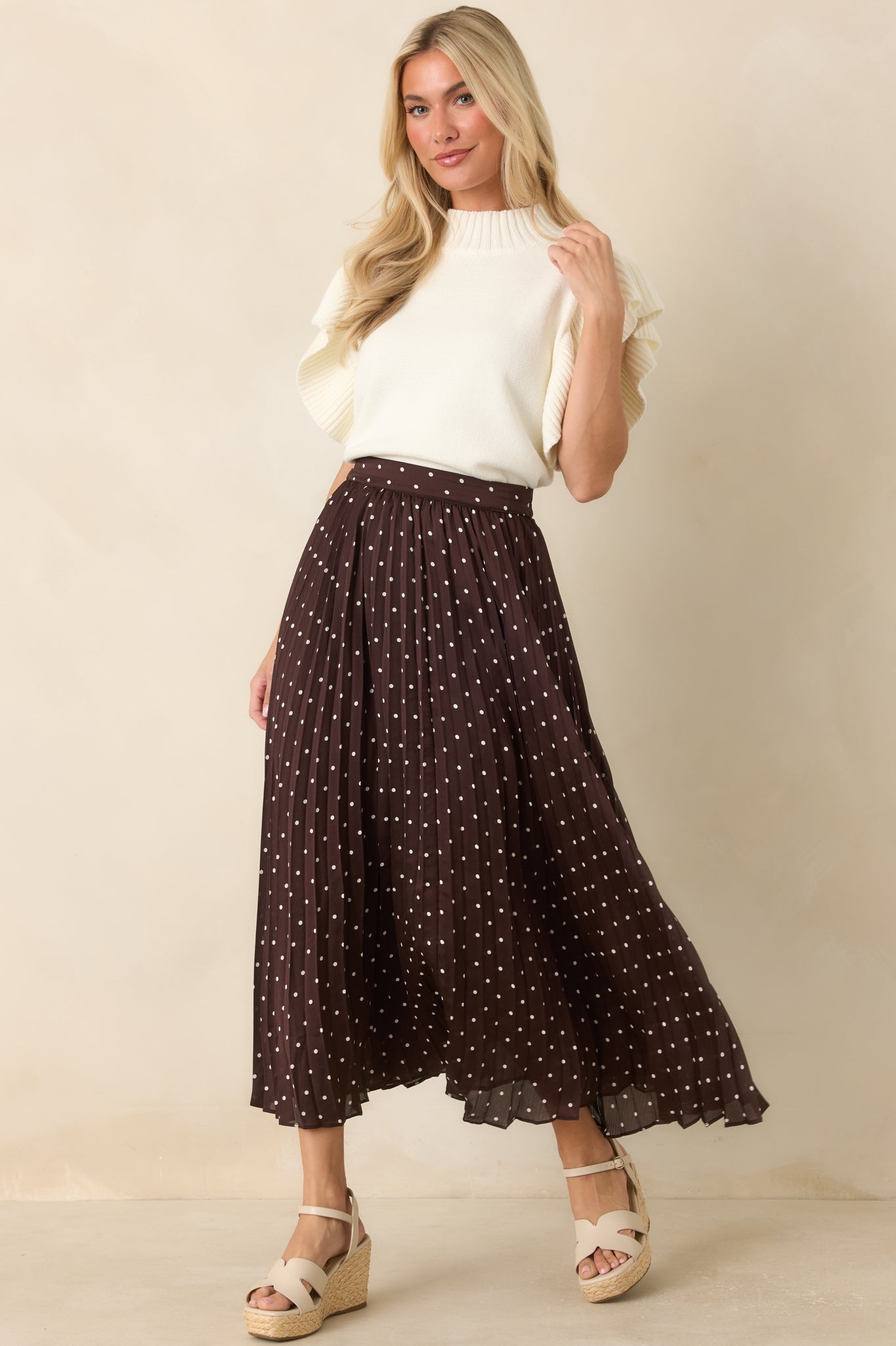 Ribbed knit top showcasing dimensional flutter sleeves and a polished everyday silhouette.