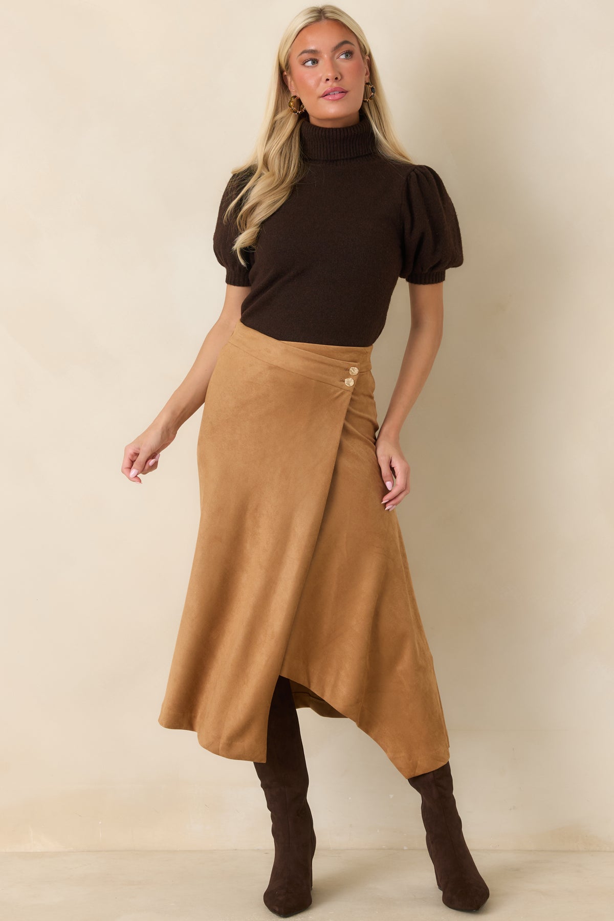 Long-sleeve knit top with a ribbed turtleneck, softly puffed shoulders, ribbed cuffs, and a clean, fitted shape designed for an effortlessly polished look.