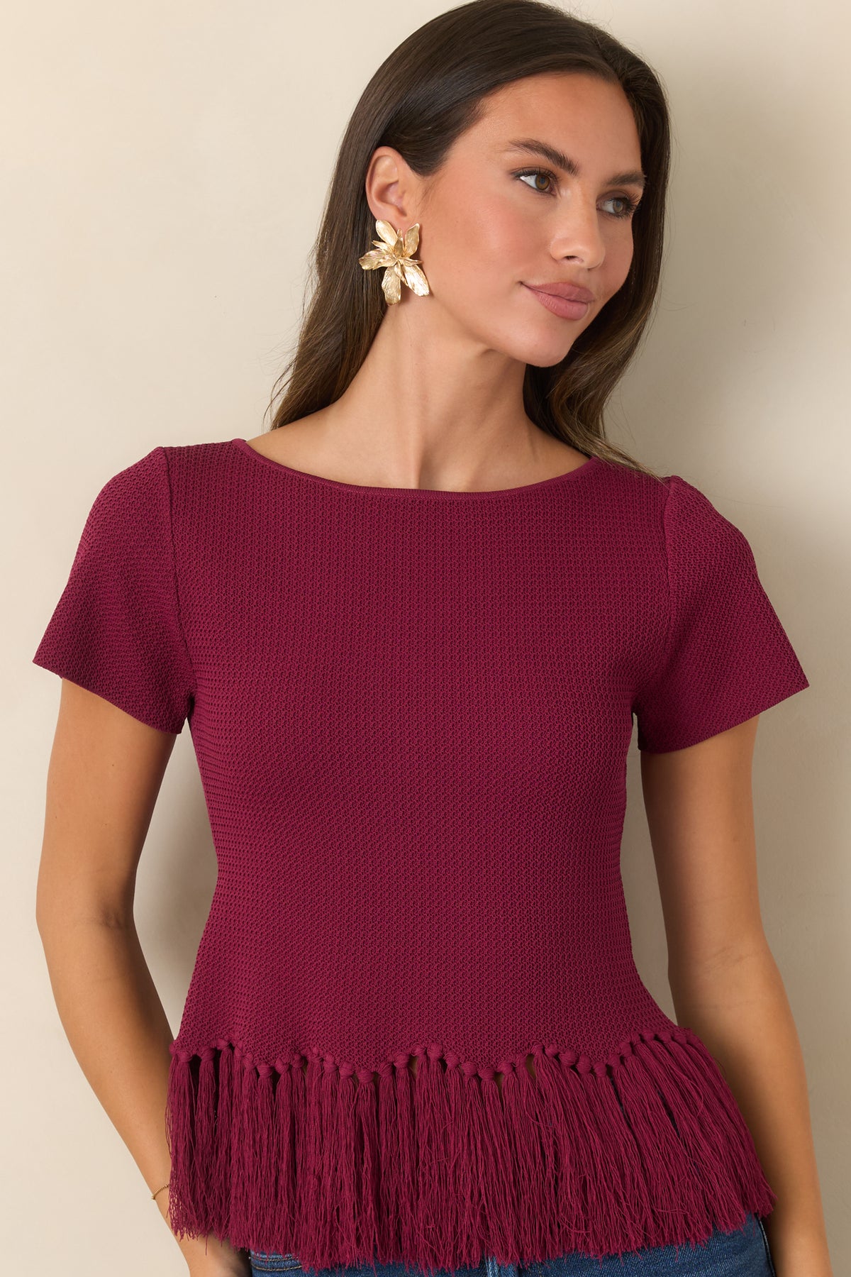 Rich berry knit texture paired with a gently shaped silhouette and fringe hem.