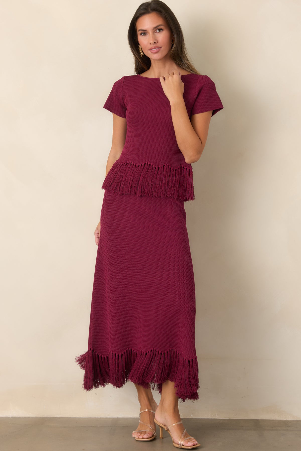 Rich berry short-sleeve knit top finished with a flowing fringe-trimmed hem.