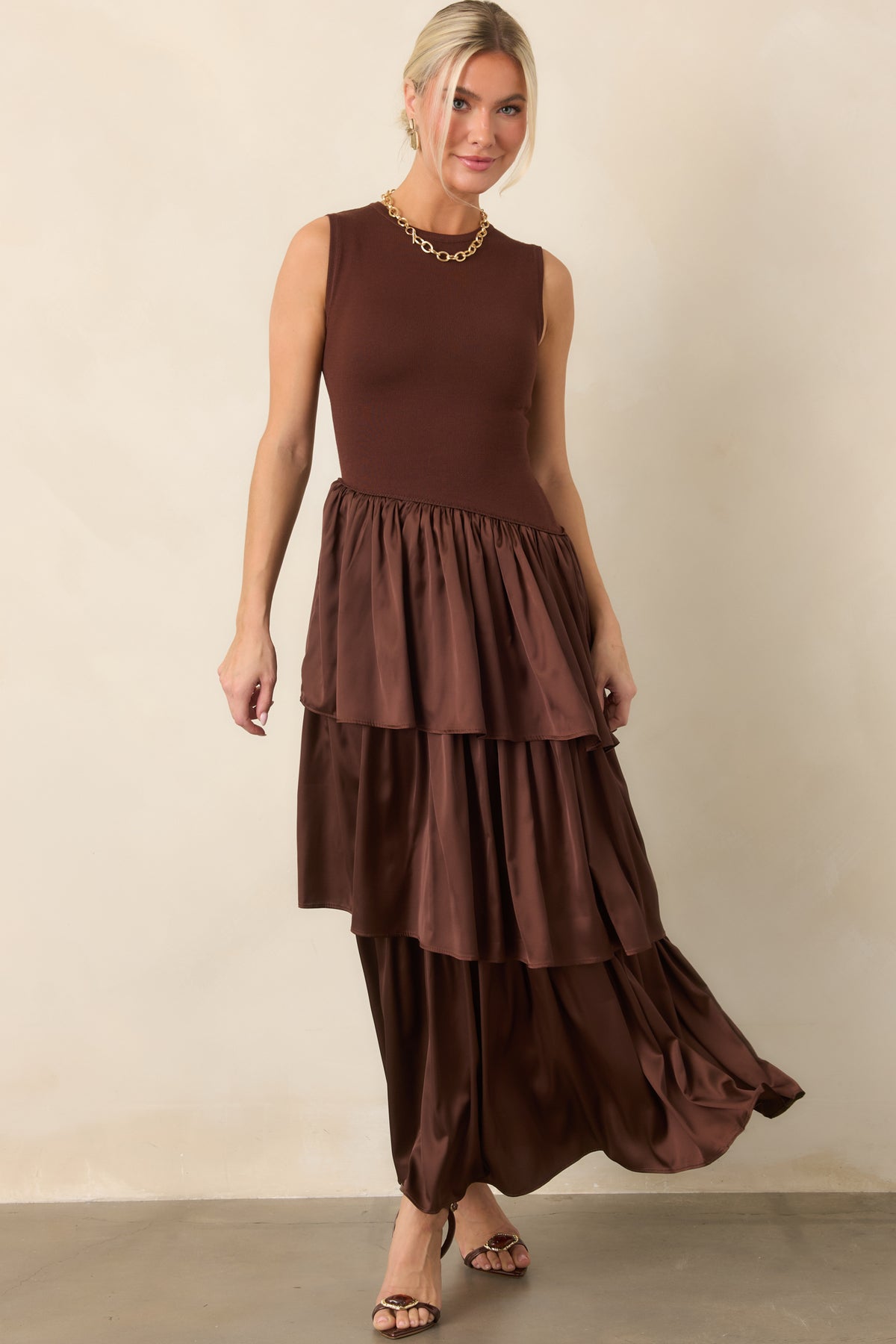 Rich brown knit bodice creates a defined upper silhouette, flowing into softly cascading woven skirt layers.