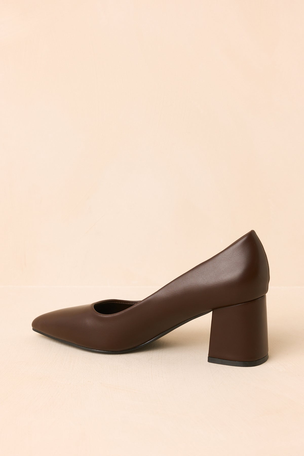 Rich brown slip-on heels showcasing the closed back and clean streamlined shape.