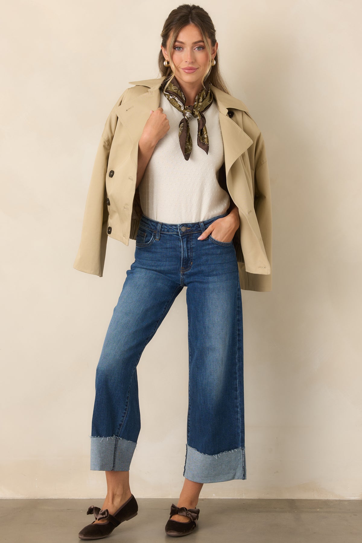 Rich brown velvet flats feature rounded toes, a statement bow strap, tonal trim, and a low heel.