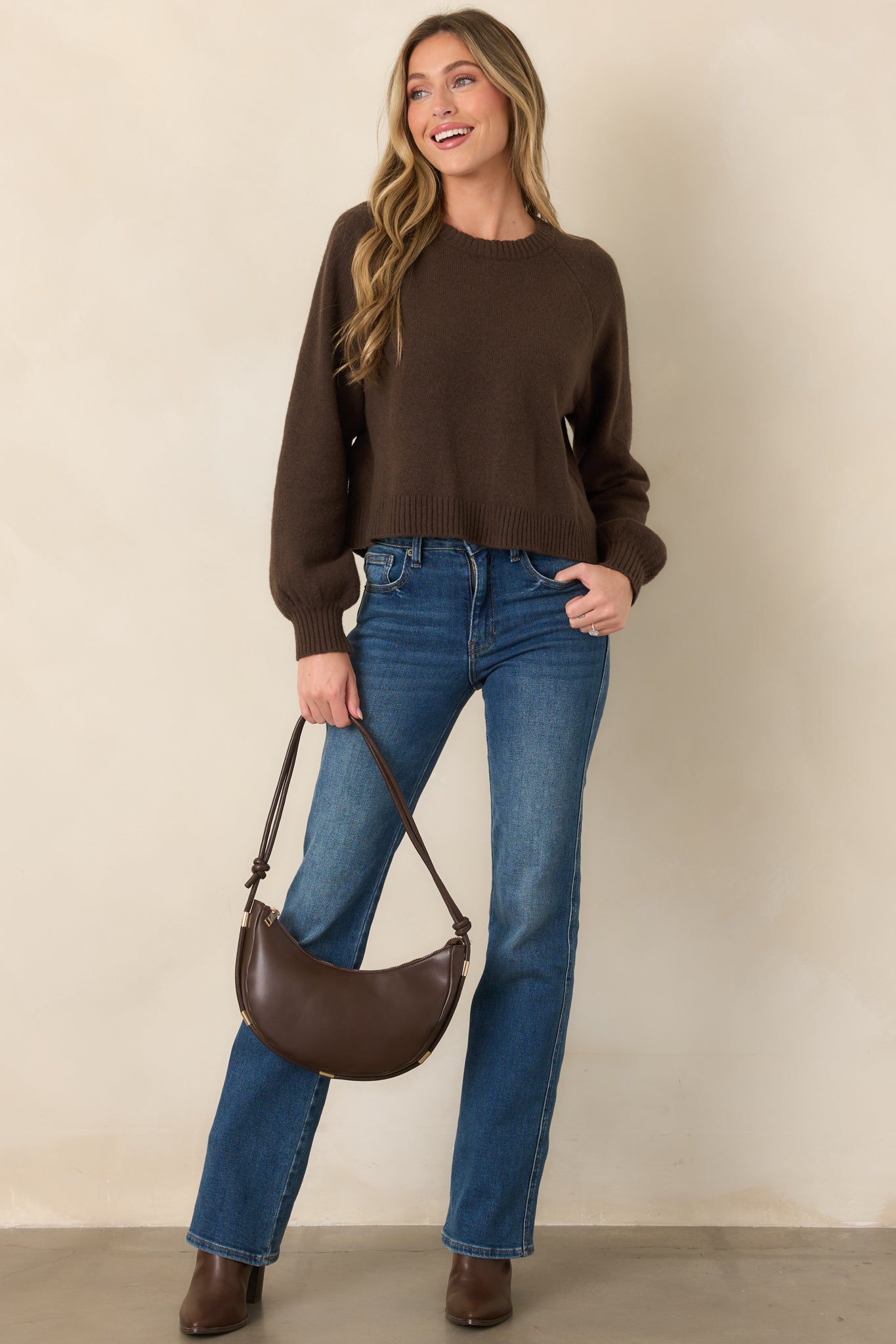 Rich chocolate brown sweater showcasing its softly gathered raglan sleeves, relaxed shape, and ribbed neckline, cuffs, and hem.