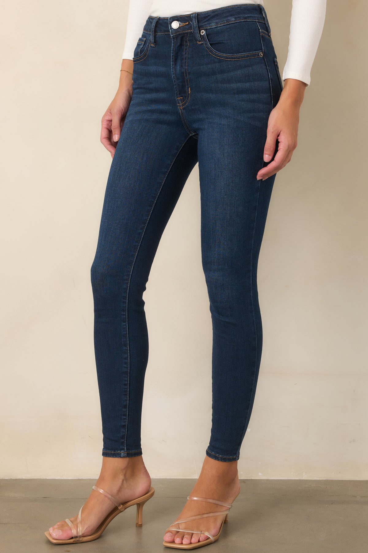 Rich dark wash pants featuring streamlined skinny legs, contrast stitching, and a structured shape that holds its form.