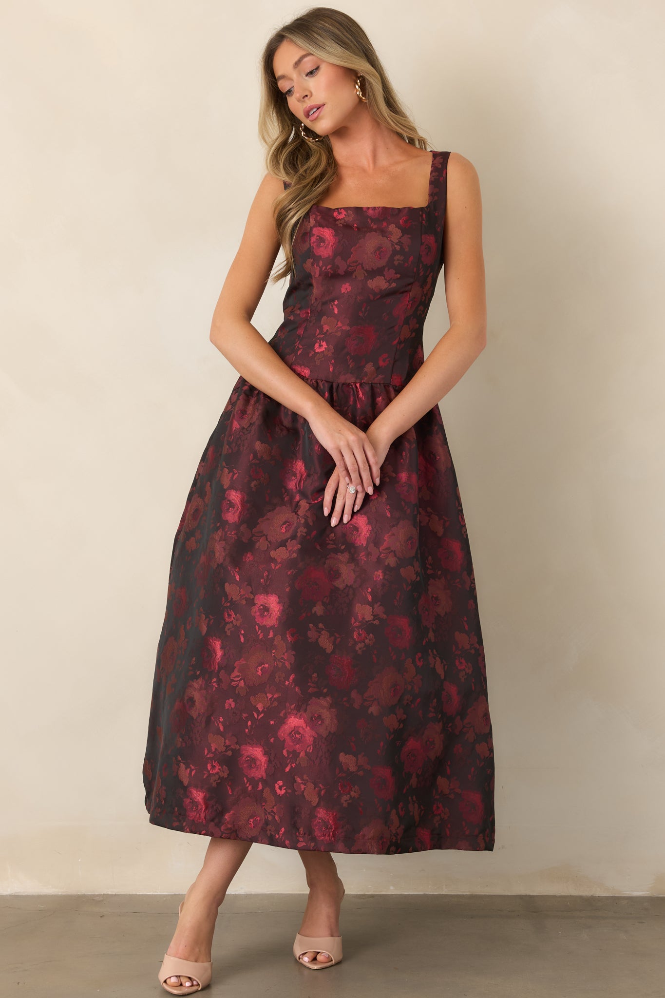Polished woven midi dress showcasing its rich floral pattern, fitted bodice, square neckline, and feminine flared skirt.