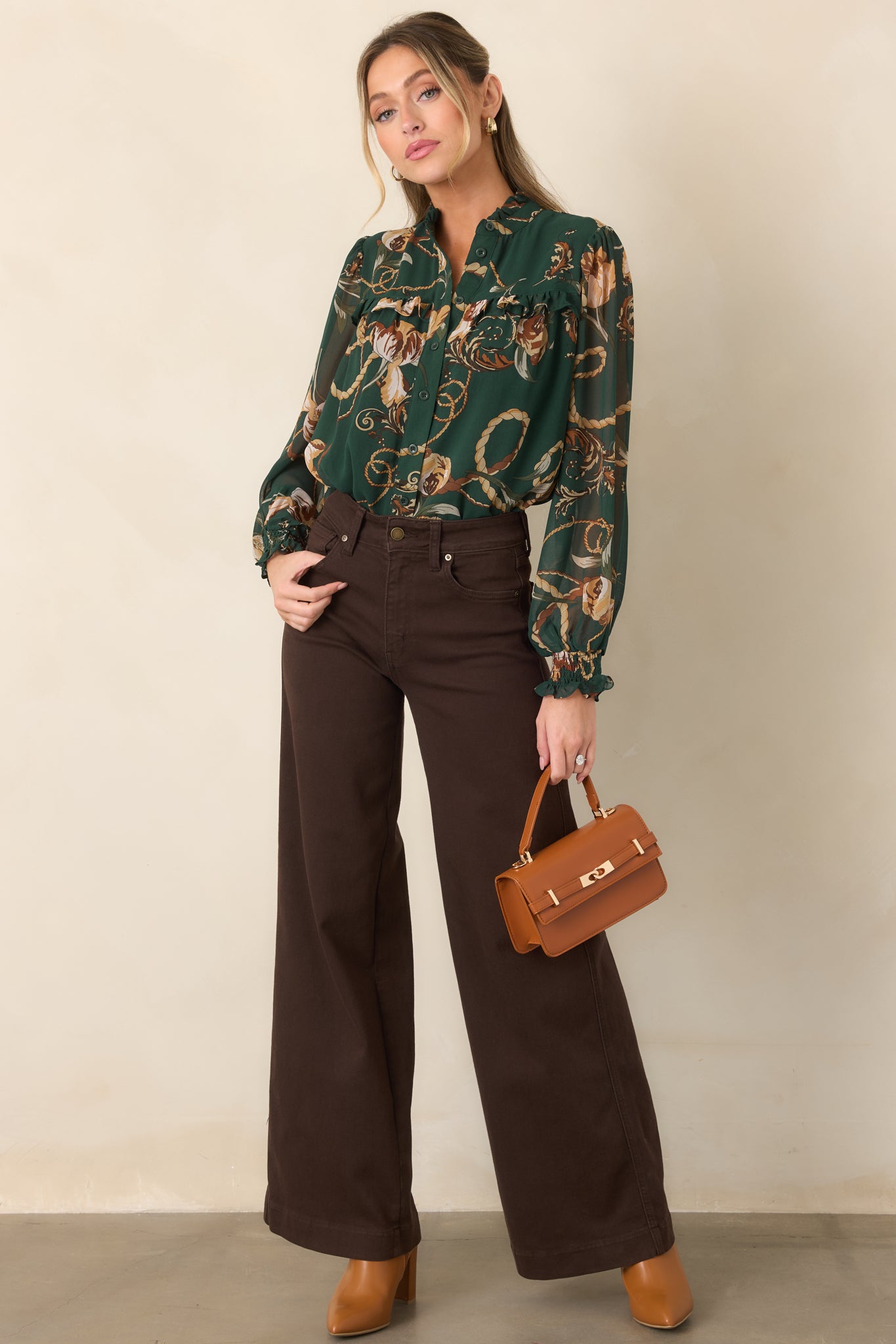 Rich forest green blouse defined by its ruffled neckline, long sheer sleeves, and gently flowing relaxed silhouette.