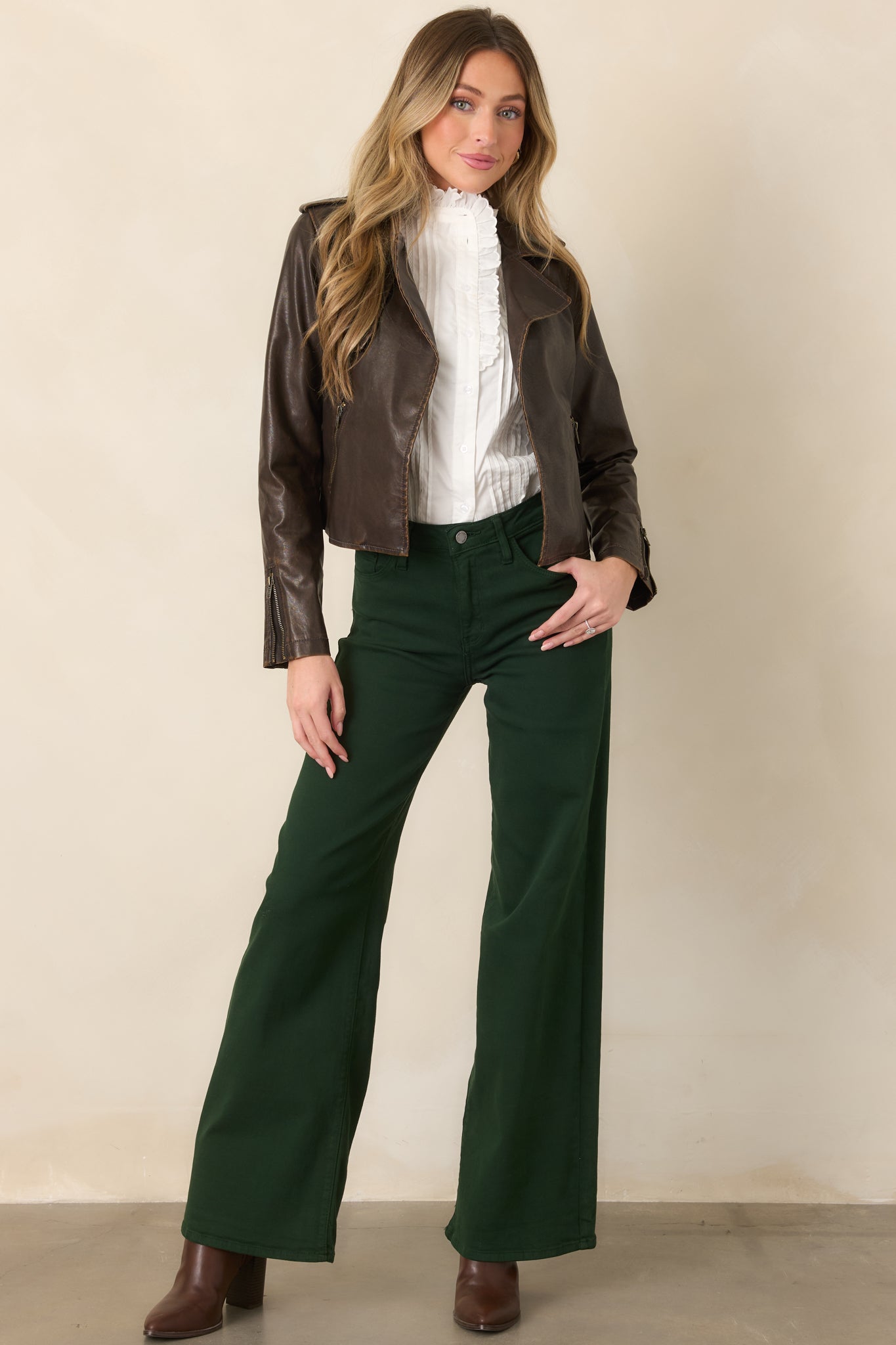 Rich green wide-leg pants showcasing the elongated silhouette, soft cotton-blend denim, and comfortable stretch construction.