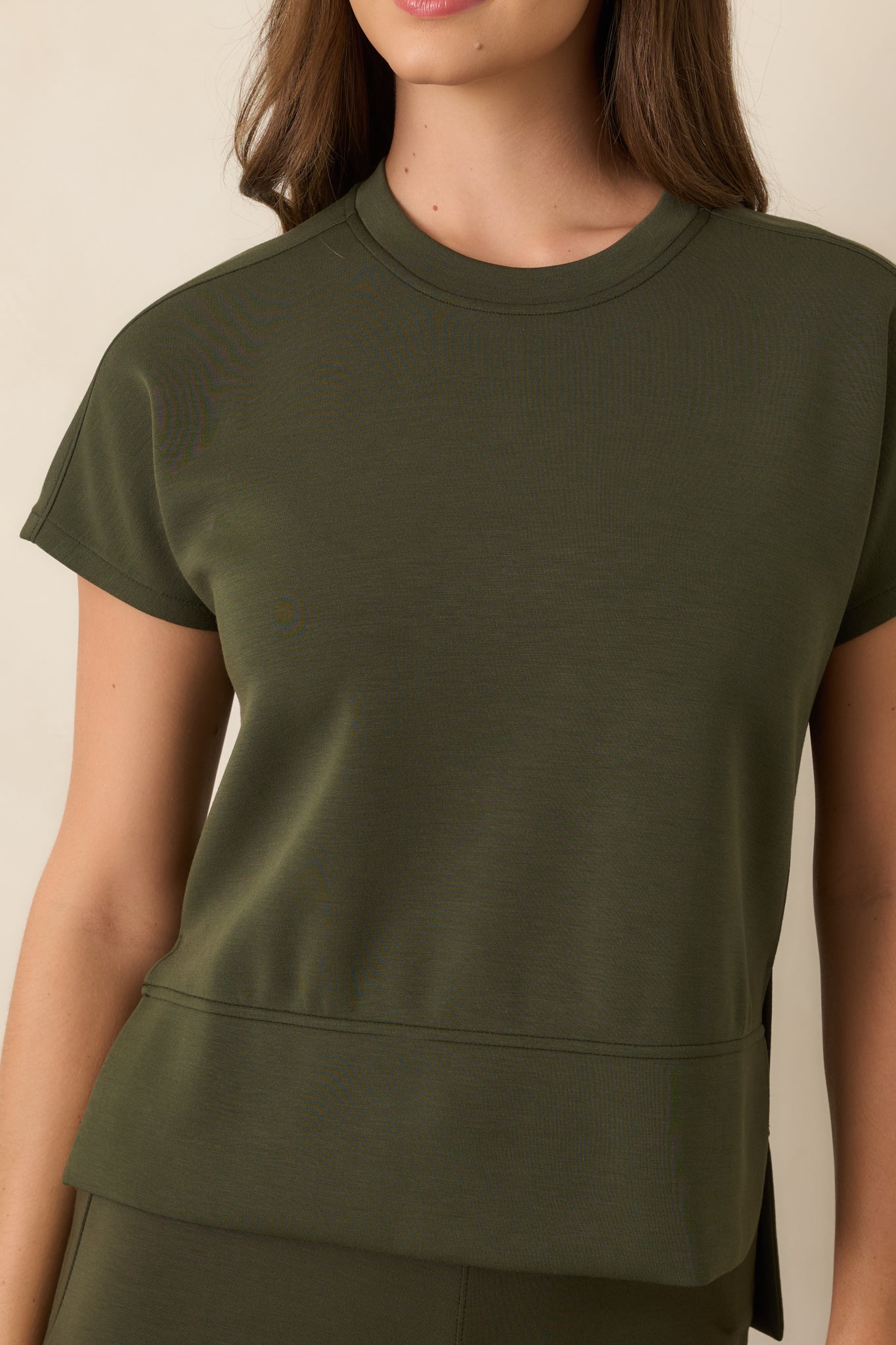 Detailed view highlighting the rich olive hue, exceptionally smooth spacer fabric, and subtle stretch of the top.