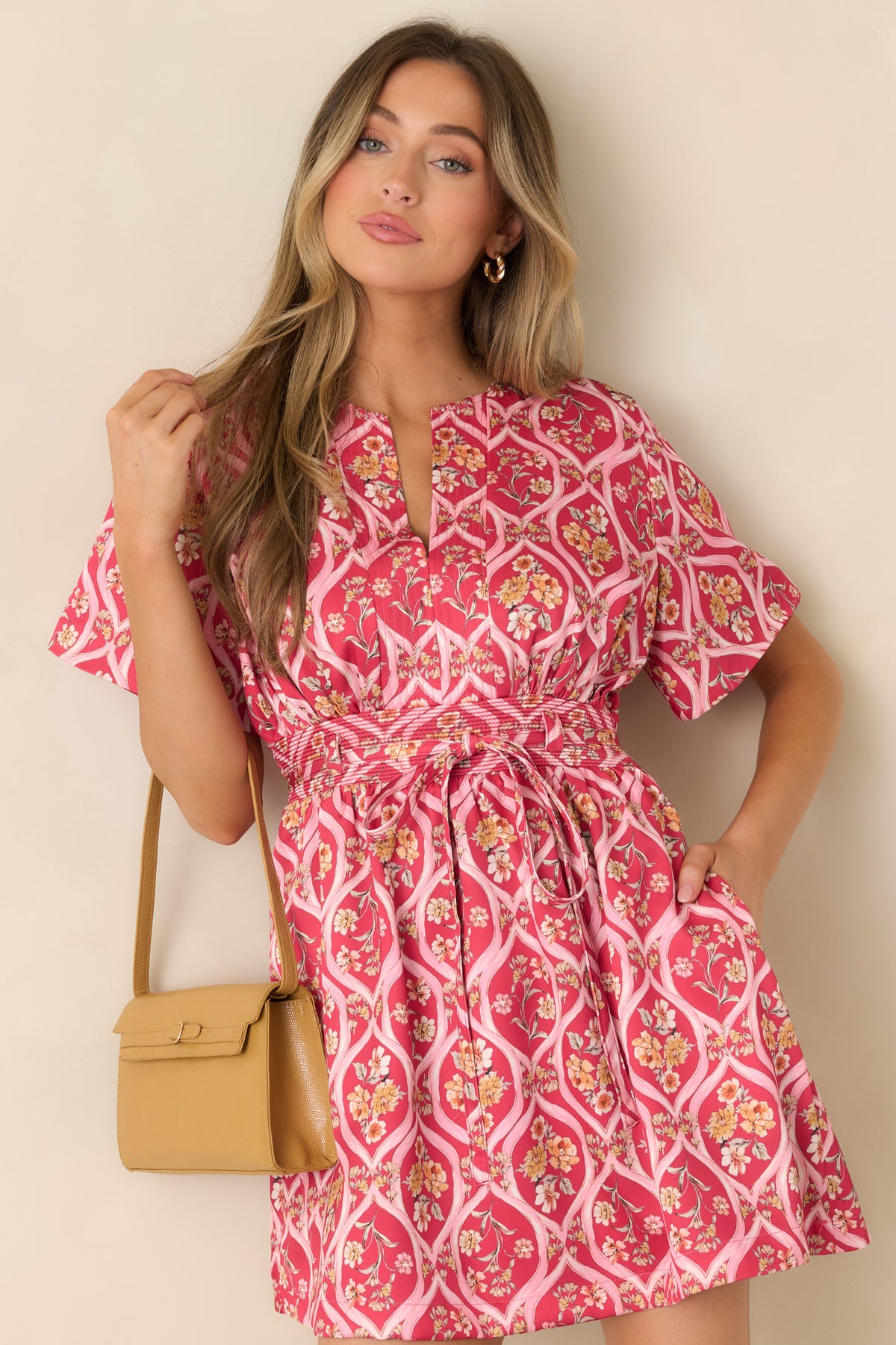 Rich pink dress with short flutter sleeves and a coordinating tie across the defined waist.