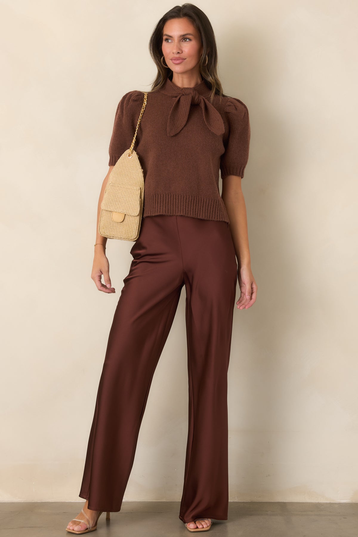 Rich rust brown pants with a smooth satin finish, clean high-rise waistband, and sweeping full-length wide-leg silhouette.